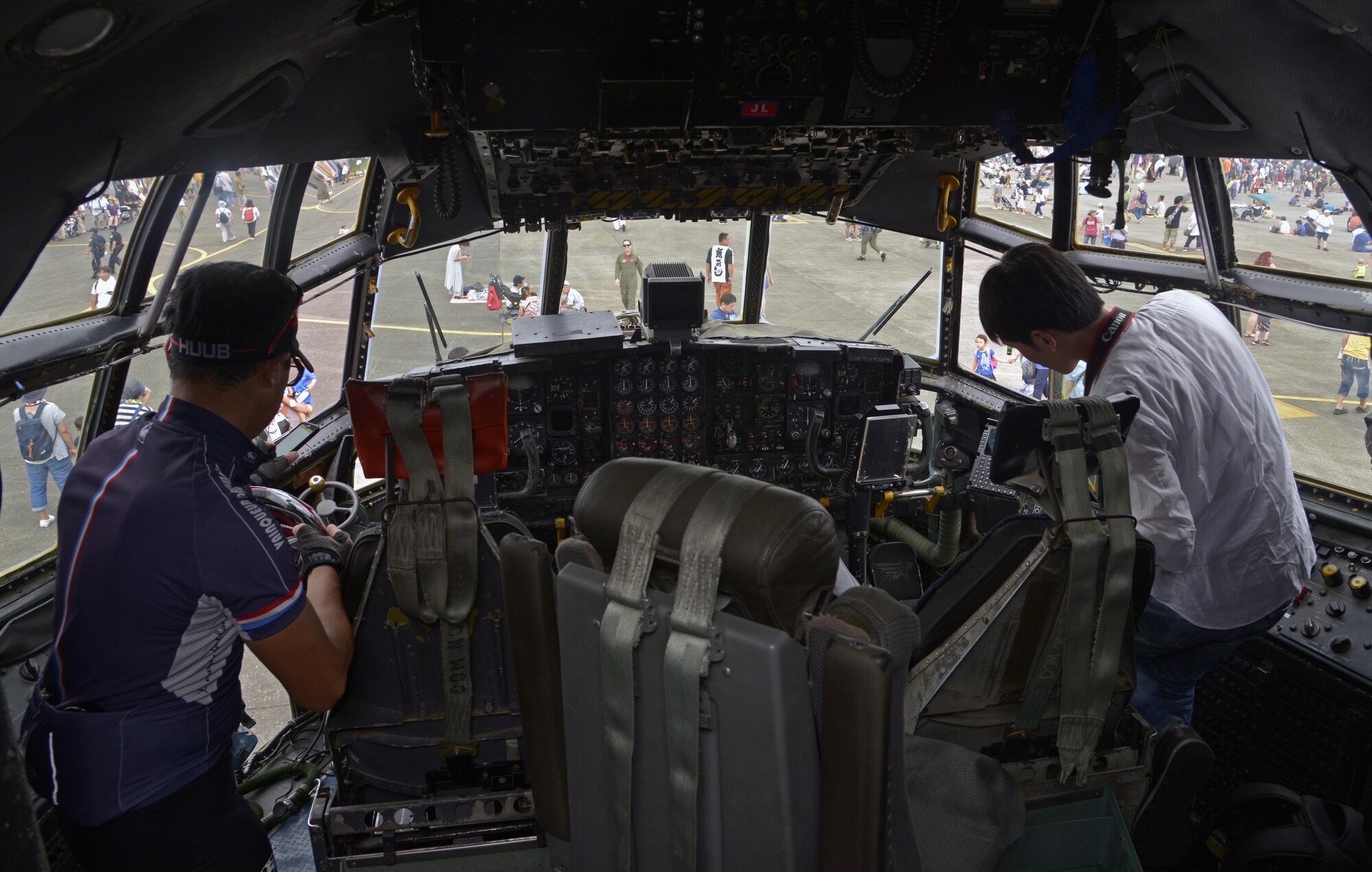 Spectators view the inside of a C-130 Hercules cockpit during the Friendship Festival at Yokota Air Base, Japan, Sept. 17, 2016. The festival was an opportunity for visitors to experience American fun and culture, while strengthening the bonds between Yokota and the local communities. (U.S. Air Force photo by Senior Airman David Owsianka/Released)