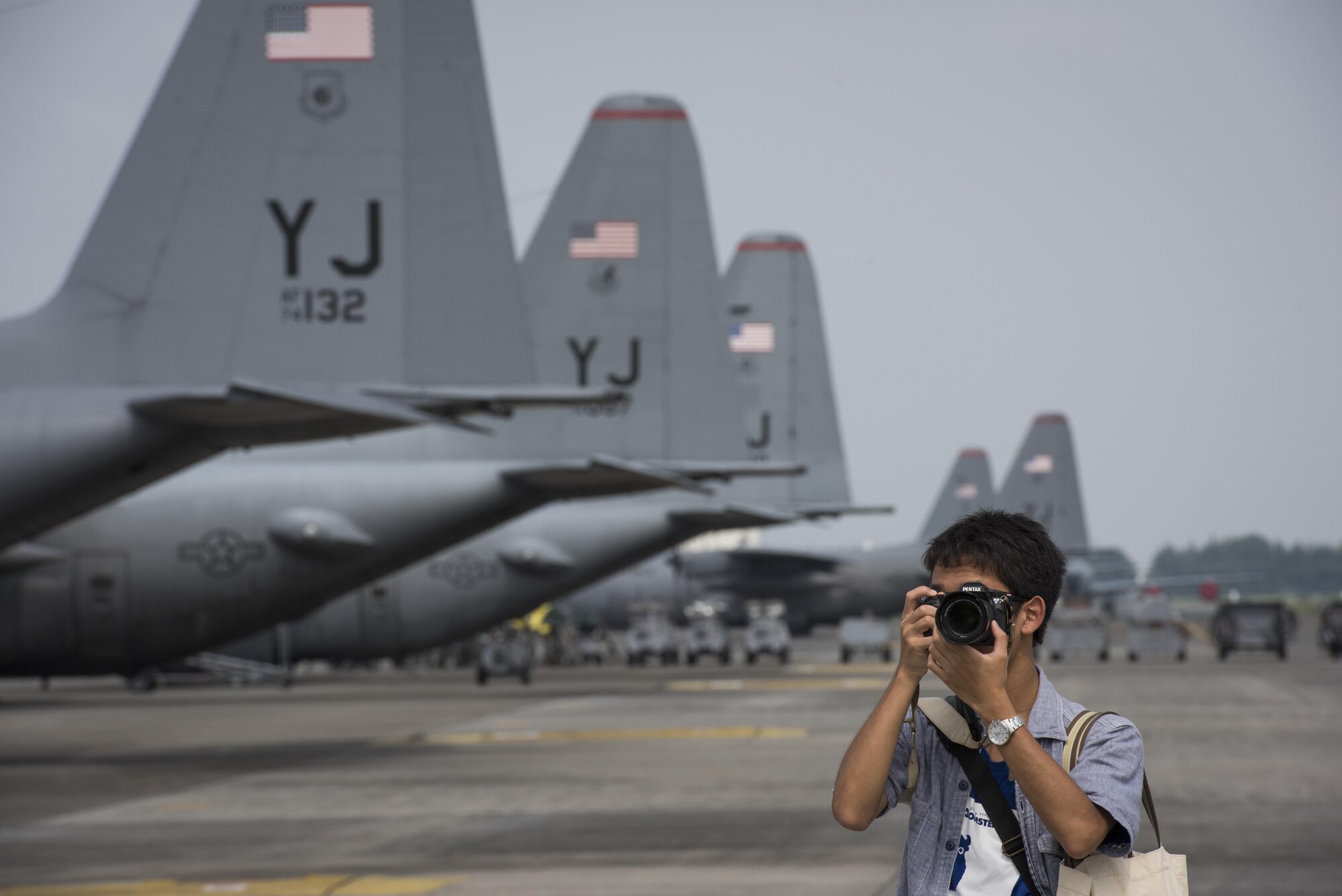 A photographer captures photos of an aircraft during the 2016 Japanese-American Friendship Festival at Yokota Air Base, Japan, Sept. 17, 2016. The festival is held annually at Yokota; more than 185,000 festivalgoers attended in 2015. (U.S. Air Force photo by Staff Sgt. Cody H. Ramirez/Released)