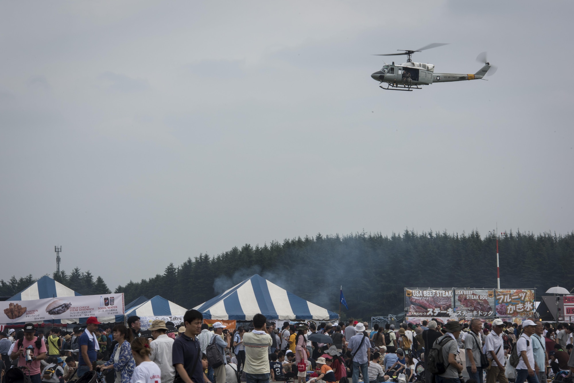 A UH-1N Iroquois hovers near the flightline during the 2016 Japanese-American Friendship Festival at Yokota Air Base, Japan, Sept. 17, 2016. The festival is held annually and offers the US military on base a chance to share their work and culture with their off-base neighbors. More than 185,000 people attended in 2015. (U.S. Air Force photo by Staff Sgt. Cody H. Ramirez/Released)