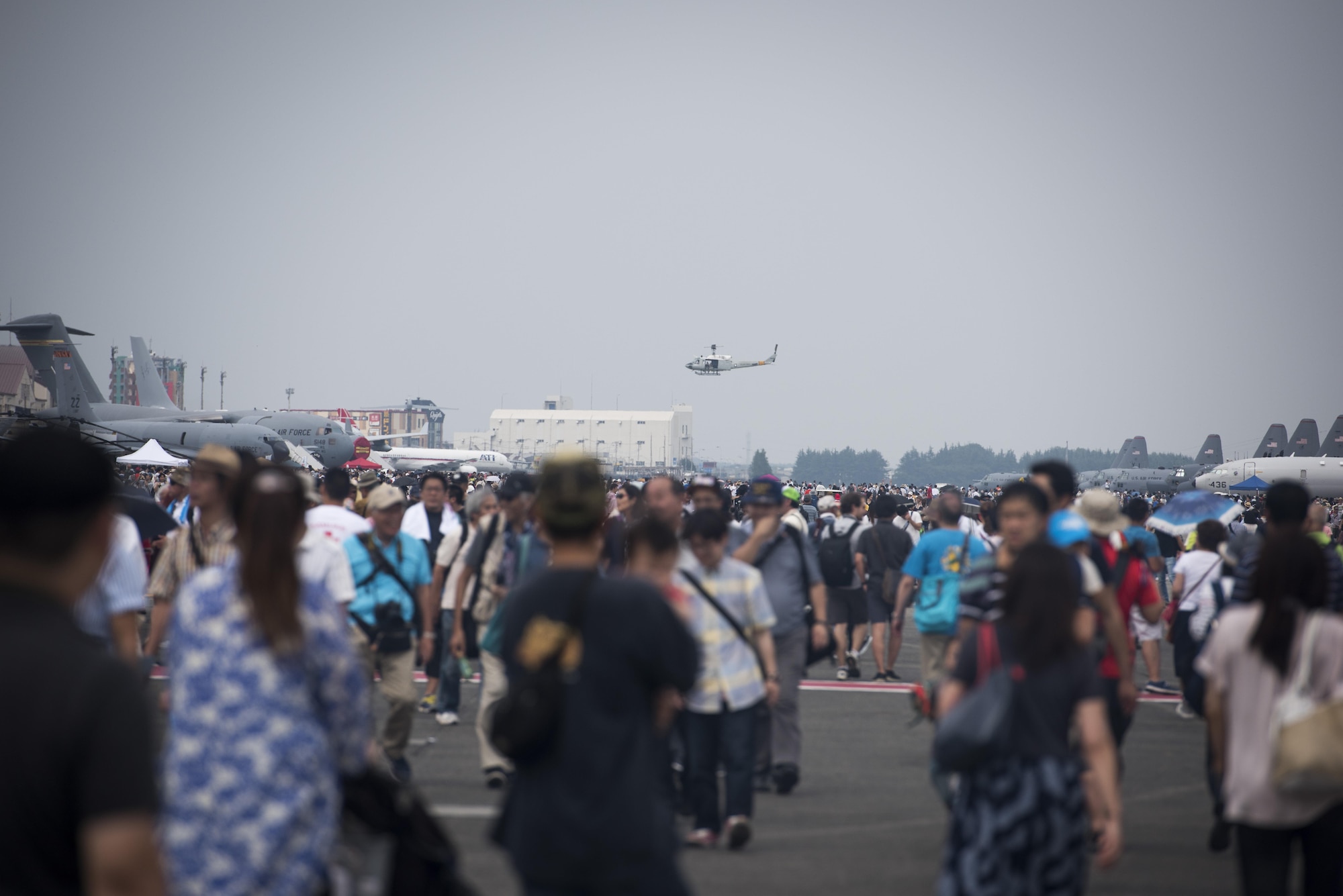 A UH-1N Iroquois hovers near the flightline during the 2016 Japanese-American Friendship Festival at Yokota Air Base, Japan, Sept. 17, 2016. The festival is held annually and offers the US military on base a chance to share their work and culture with their off-base neighbors. More than 185,000 people attended in 2015. (U.S. Air Force photo by Staff Sgt. Cody H. Ramirez/Released)