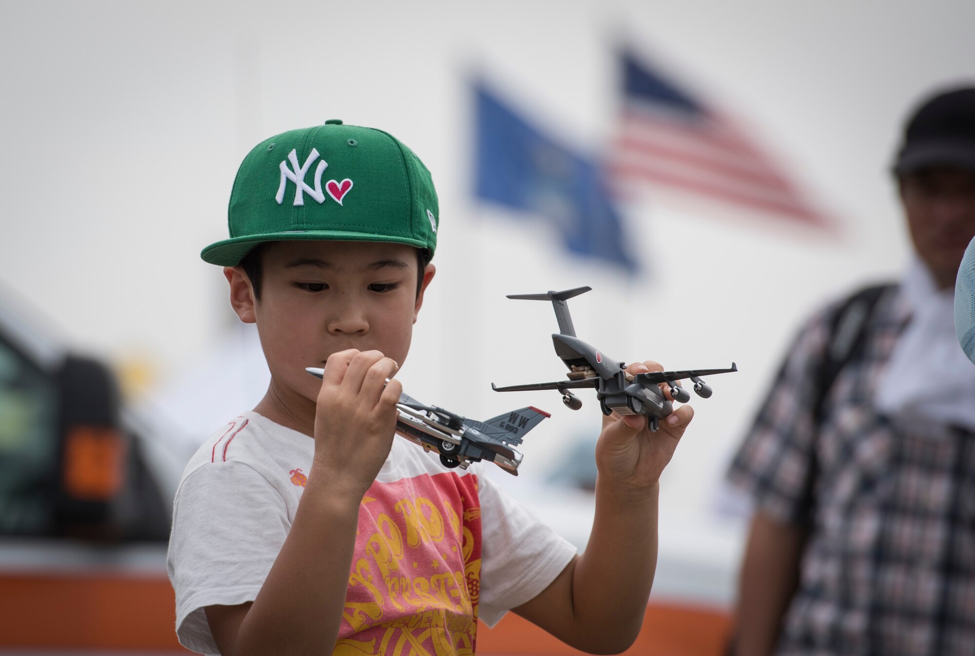 A boy plays with toy aircraft during the 2016 Japanese-American Friendship Festival at Yokota Air Base, Japan, Sept. 17, 2016. Tens of thousands of people attend the festival every year to learn more about the US military and American culture. (U.S. Air Force photo by Staff Sgt. Cody H. Ramirez/Released)