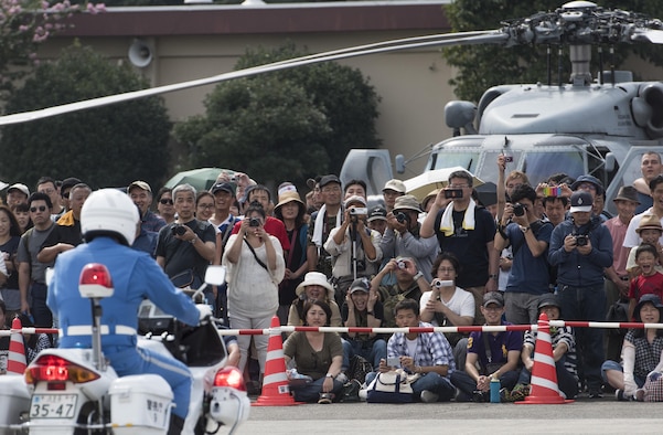 A crowd watches the Tokyo Metropolitan Police Department 9th District traffic mobile unit conduct their motorcycle demonstration during the 2016 Japanese-American Friendship Festival at Yokota Air Base, Japan, Sept. 17, 2016. The festival hosted food vendors, static aircraft displays, live entertainment and military and government demonstrations. (U.S. Air Force photo by Staff Sgt. Cody H. Ramirez/Released)