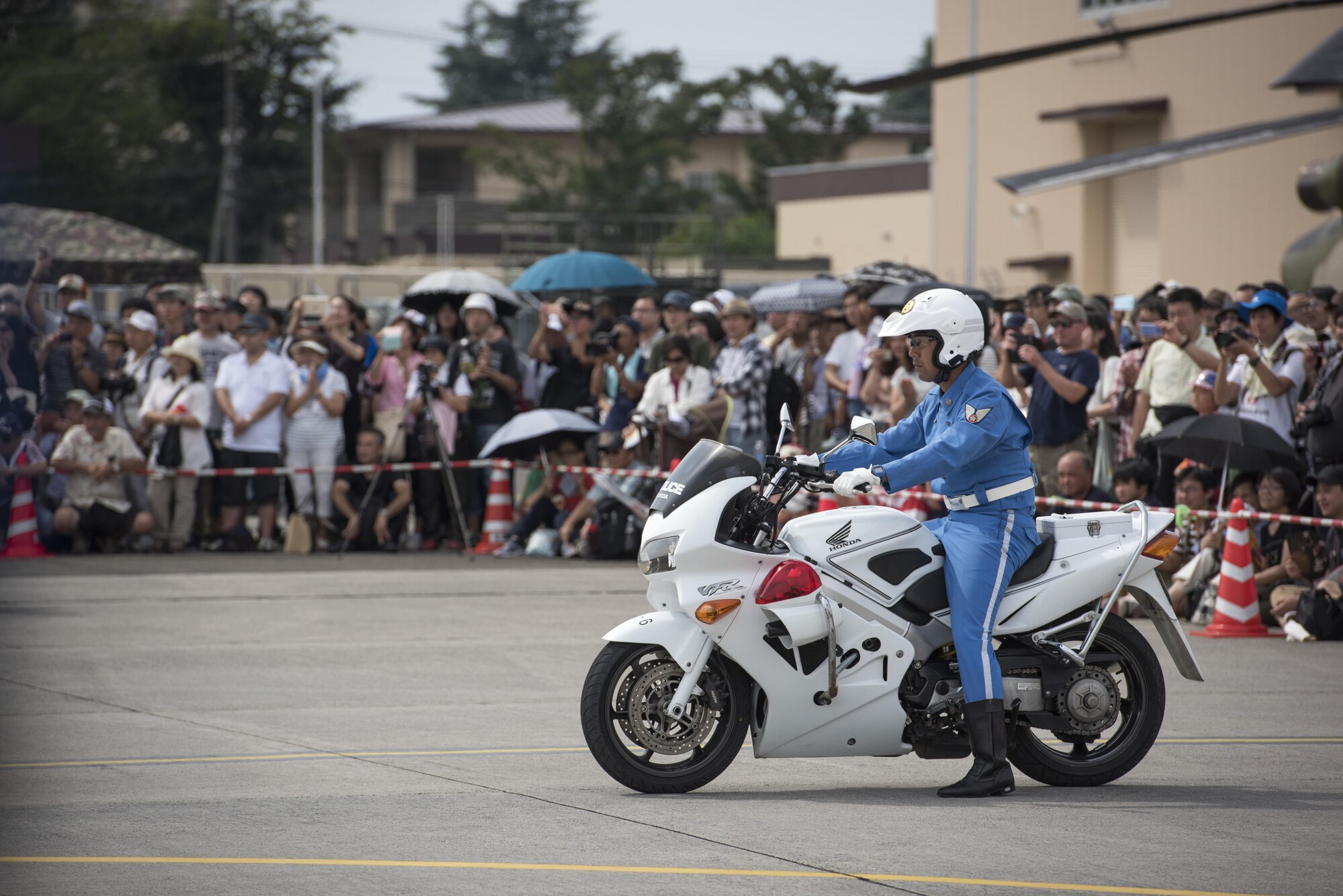 A member of the Tokyo Metropolitan Police Department 9th District traffic mobile unit prepares for his next movement of a motorcycle demonstration during the 2016 Japanese-American Friendship Festival at Yokota Air Base, Japan, Sept. 17, 2016. The festival hosted food vendors, static aircraft displays, live entertainment and military and government demonstrations. (U.S. Air Force photo by Staff Sgt. Cody H. Ramirez/Released)