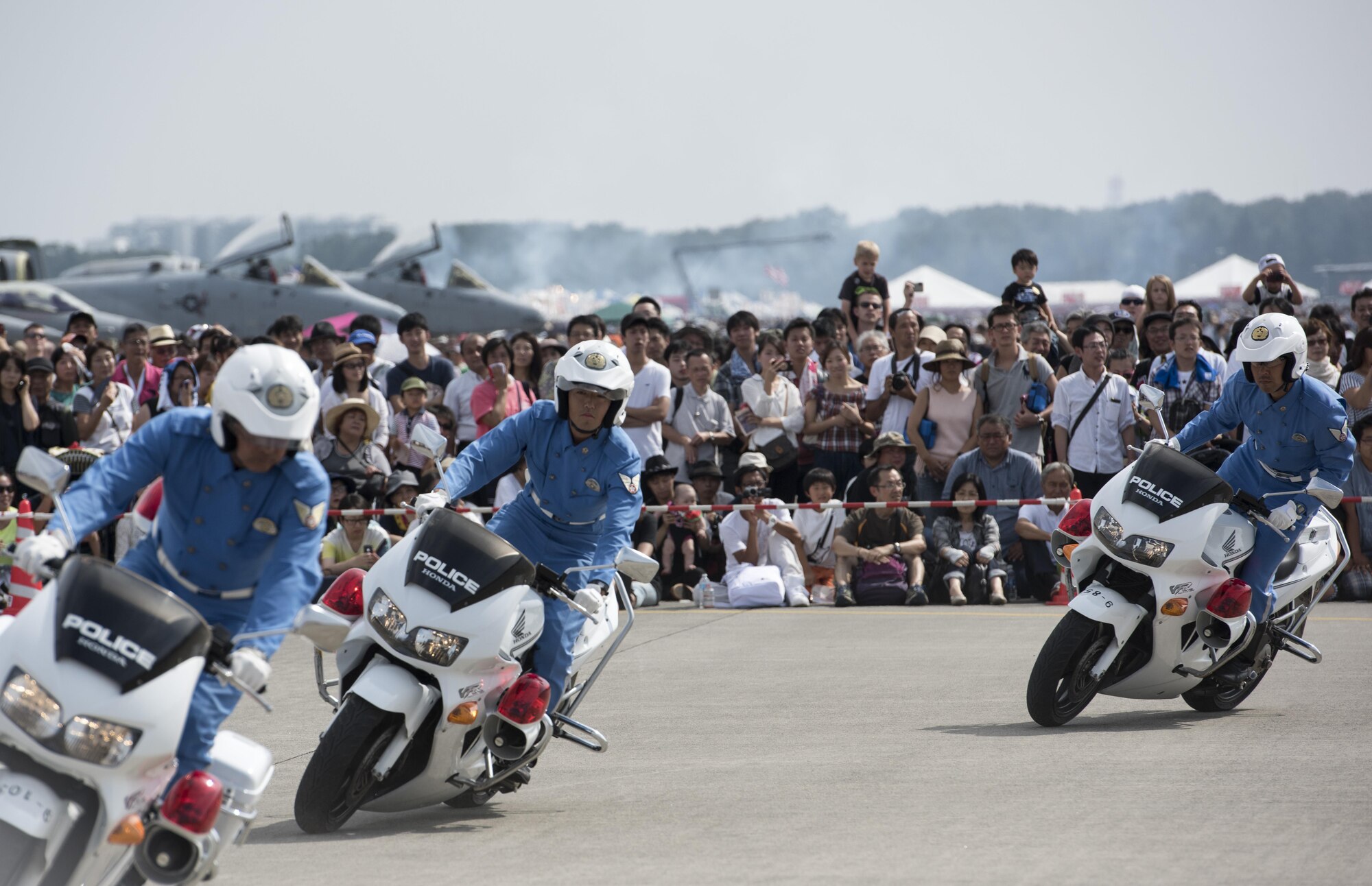 Members of the Tokyo Metropolitan Police Department 9th District traffic mobile unit conduct their motorcycle demonstration during the 2016 Japanese-American Friendship Festival at Yokota Air Base, Japan, Sept. 17, 2016. The festival hosted food vendors, static aircraft displays, live entertainment and military and government demonstrations. (U.S. Air Force photo by Staff Sgt. Cody H. Ramirez/Released)

