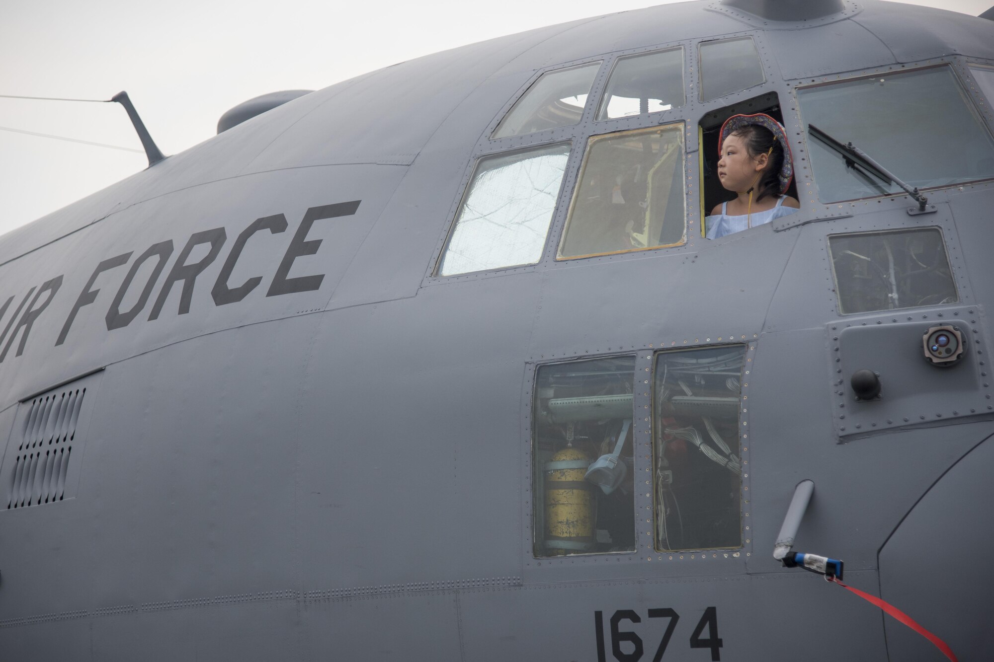 A child pokes her head out of the window of a C-130 Hercules at the 2016 Friendship Festival at Yokota Air Base, Japan, Sept. 17, 2016. In 2015, more than 185,000 people attended the festival. (U.S. Air Force photo by Staff Sgt. Michael Washburn/Released)