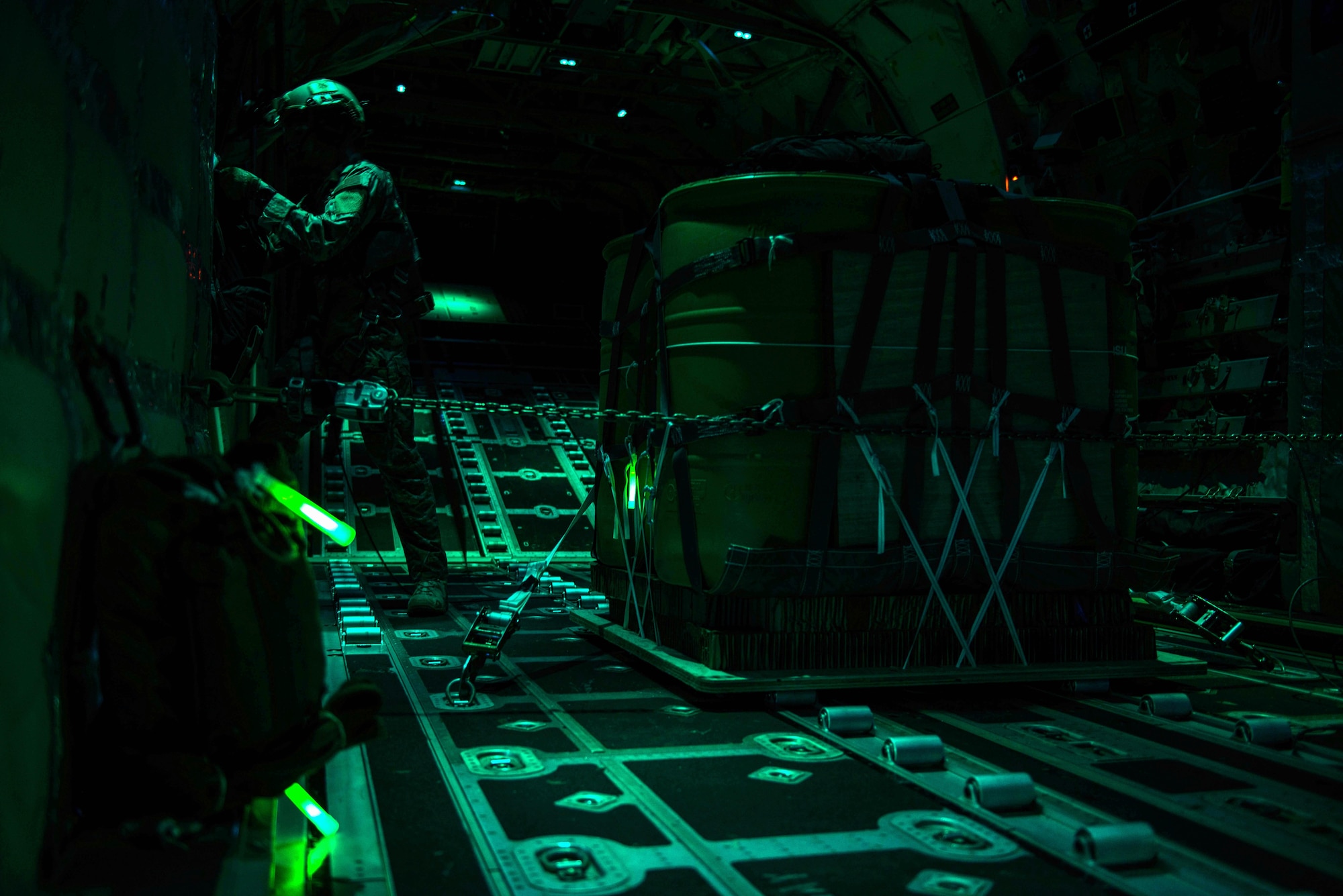 An MC-130J Commando II loadmaster, assigned to the 67th Special Operations Squadron, runs checklist procedures prior to an air drop during a night training mission on RAF Mildenhall, England, Sept. 14, 2016. Enlisted loadmasters are an essential part of an MC-130J aircrew and perform a variety of tasks from the rear of the aircraft before, during and after flights.  (U.S. Air Force photo by 1st Lt Chris Sullivan/Released)