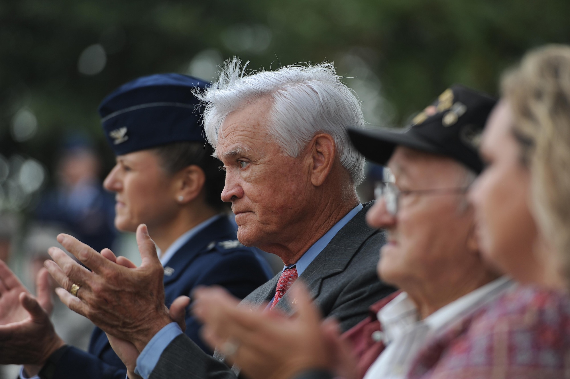 U.S. Air Force Lt. Col. (Ret.) Barry Bridger, former 43rd Tactical Fighter Squadron F-4 Phantom aircraft commander, claps during a POW/MIA closing ceremony at Joint Base Langley-Eustis, Va., Sept. 15, 2016. Bridger was shot down, captured and imprisoned for 2,232 days (six years) during the Vietnam War. The third Friday in September has been observed as POW/MIA Recognition Day since 1986. Since World War I, more than 150,000 Americans have been held as prisoners of war and more than 83,400 service members are still unaccounted for. (U.S. Air Force photo by Staff Sgt. Nick Wilson)