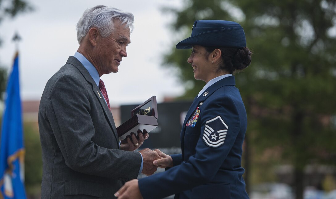 U.S. Air Force Lt. Col. (Ret.) Barry Bridger, former 43rd Tactical Fighter Squadron F-4 Phantom aircraft commander, receives a shadowbox from Master Sgt. Vanessa Reeves, Prisoner of War/Missing in Action committee chairman, during a POW/MIA closing ceremony  at Joint Base Langley-Eustis, Va., Sept. 15, 2016. Bridger is a highly decorated veteran and survivor of six years in Vietnam's infamous “Hanoi Hilton” prison camp. (U.S. Air Force photo by Staff Sgt. Nick Wilson)



