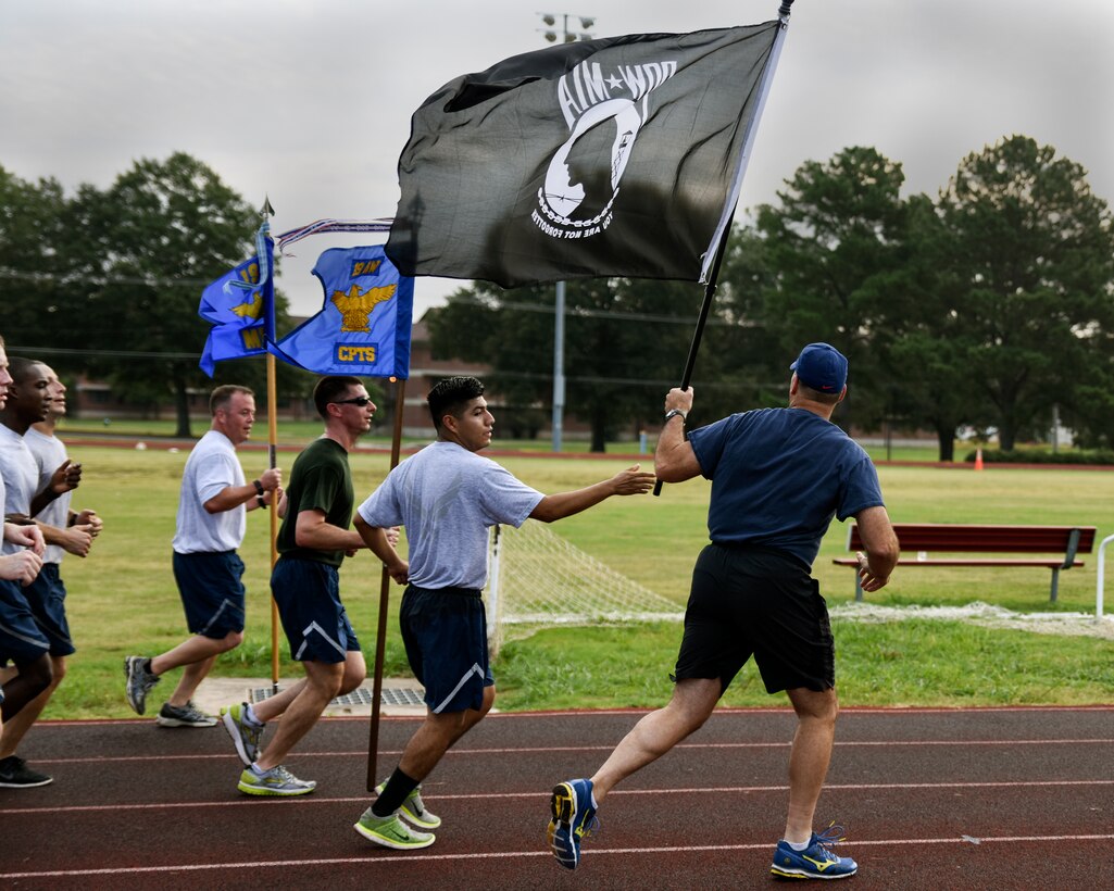 Col. Christopher Montanaro, the 189th Maintenance Group commander, receives the POW/MIA flag during the POW/MIA Vigil Run Sept. 17, 2016, at Little Rock Air Force Base, Ark. The run lasted 24 hours and was in remembrance of all service members who were prisoners of war or have been missing in action. (U.S. Air National Guard photo by Tech. Sgt. Jessica Condit) 