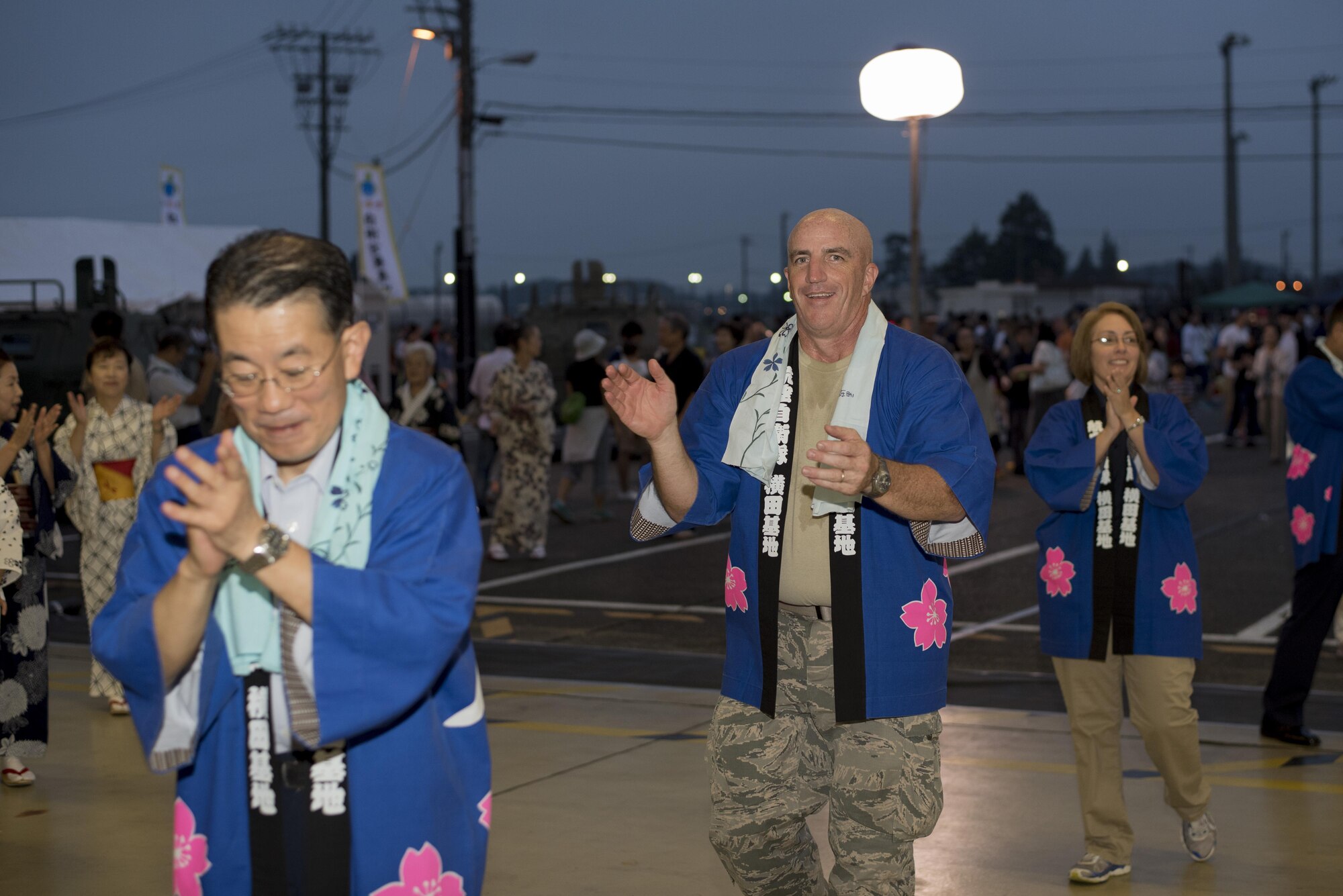 Col. Kenneth Moss, 374th Airlift Wing commander, performs in a Bon dance during the 2016 Friendship Festival at Yokota Air Base, Japan, Sept. 18, 2016. Moss participated in the dance with other Yokota leadership. (U.S. Air Force photo by Staff Sgt. Michael Washburn/Released)
