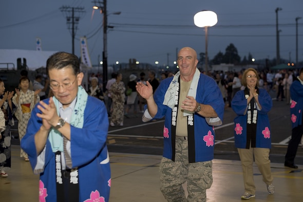 Col. Kenneth Moss, 374th Airlift Wing commander, performs in a Bon dance during the 2016 Friendship Festival at Yokota Air Base, Japan, Sept. 18, 2016. Moss participated in the dance with other Yokota leadership. (U.S. Air Force photo by Staff Sgt. Michael Washburn/Released)