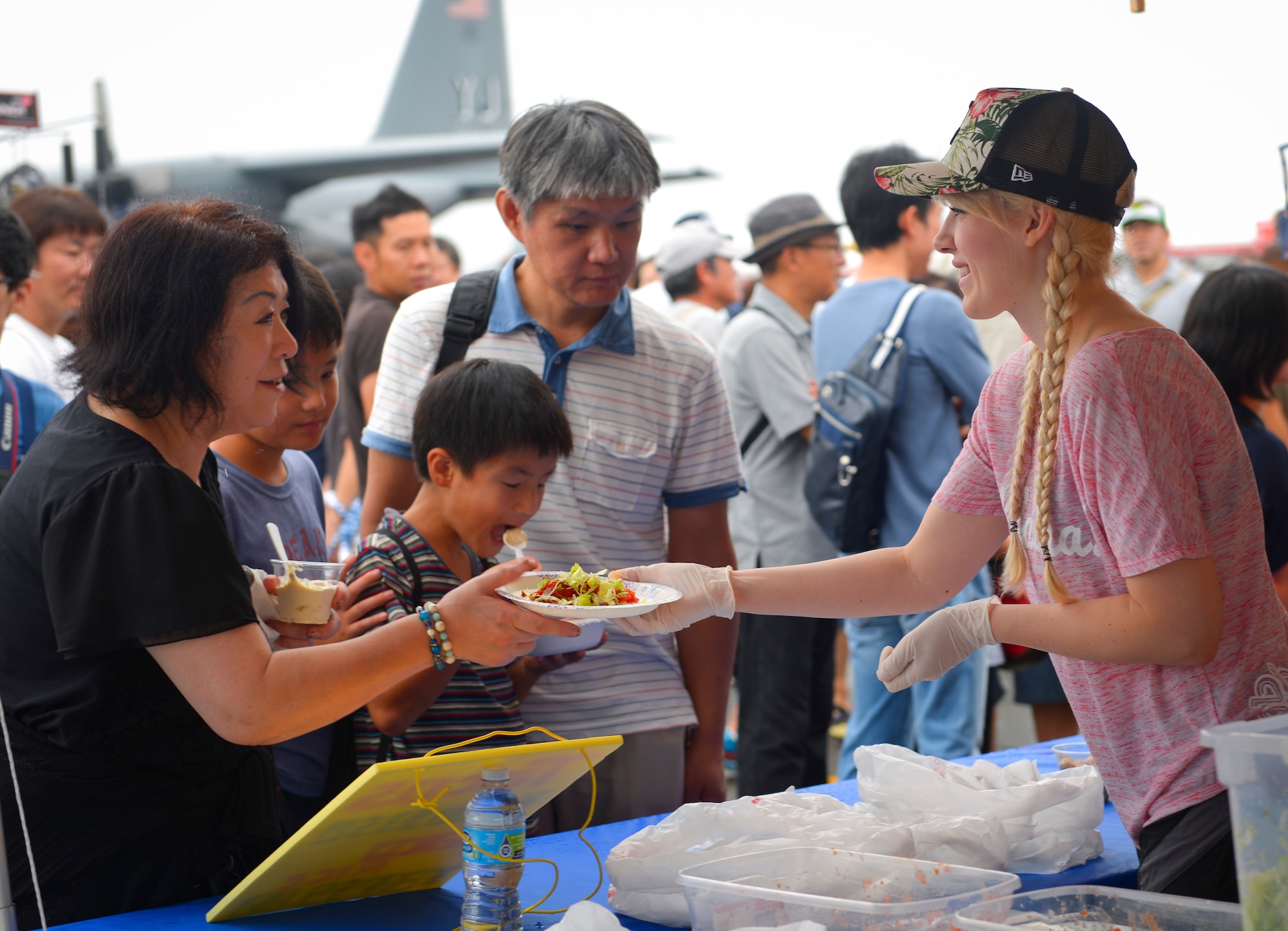Festivalgoers purchase food from a booth at the 2016 Japanese-American Friendship Festival at Yokota Air Base, Japan, Sept. 18, 2016. The festival is held annually and offers the US military on base a chance to share their work and culture with their off-base neighbors. More than 185,000 people attended in 2015. (U.S. Air Force photo by Airman 1st Class Elizabeth Baker/Released)