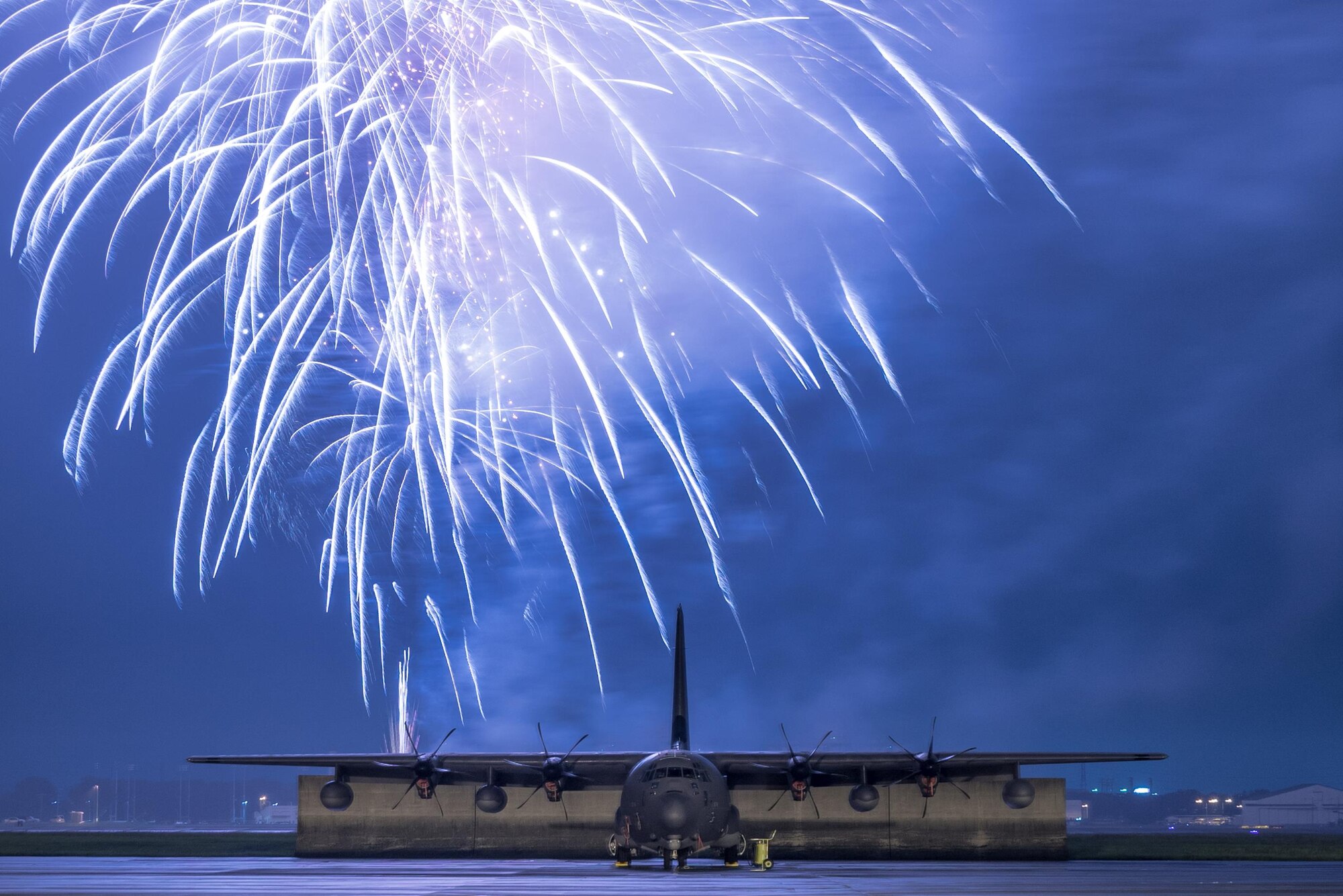 Fireworks explode over a C-130J Super Hercules at the 2016 Japanese-American Friendship Festival at Yokota Air Base, Japan, Sept. 18, 2016. Tens of thousands of people attend the festival every year to learn more about the US military and American culture.  (U.S. Air Force photo by Senior Airman Delano Scott/Released)