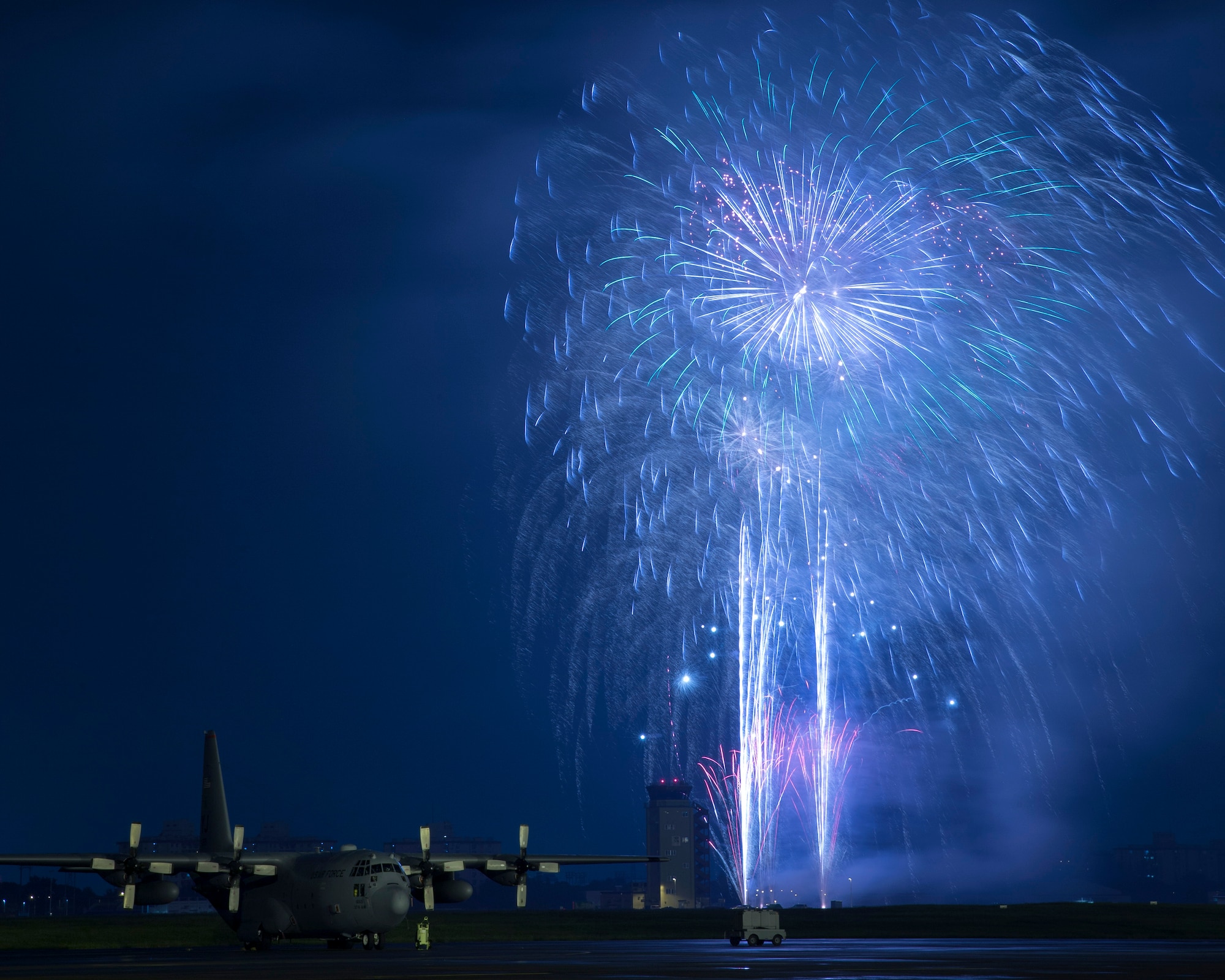 Fireworks explode behind a C-130 Hercules at the 2016 Friendship Festival at Yokota Air Base, Japan, Sept. 18, 2016. Ten of thousands visitors attended the festival designed to bolster the bi-lateral relationship shared between the United States and Japan. In addition to static displays and live music, the festival offered a variety of American and Japanese food. (U.S. Air Force photo by Yasuo Osakabe/Released)