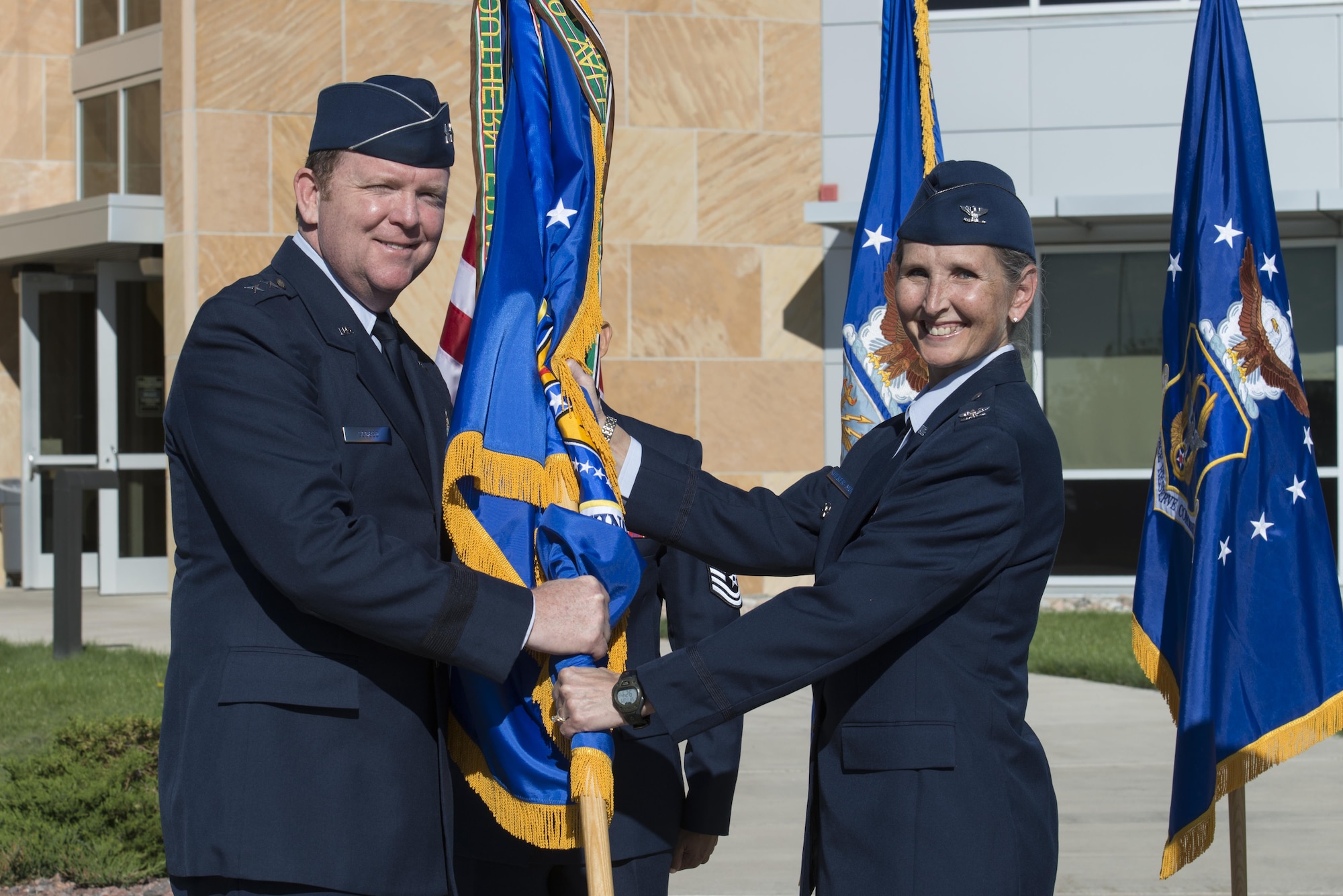 Col. Traci L. Kueker-Murphy receives the 310th Space Wing colors from Maj. Gen. Richard W. Scobee, 10th Air Force commander, during a change of command ceremony as she assumes command of the 310th Space Wing, Schriever AFB, Colo., Sept. 17, 2016. 
(U.S. Air Force photo by Staff Sgt. Christopher Moore/Released)