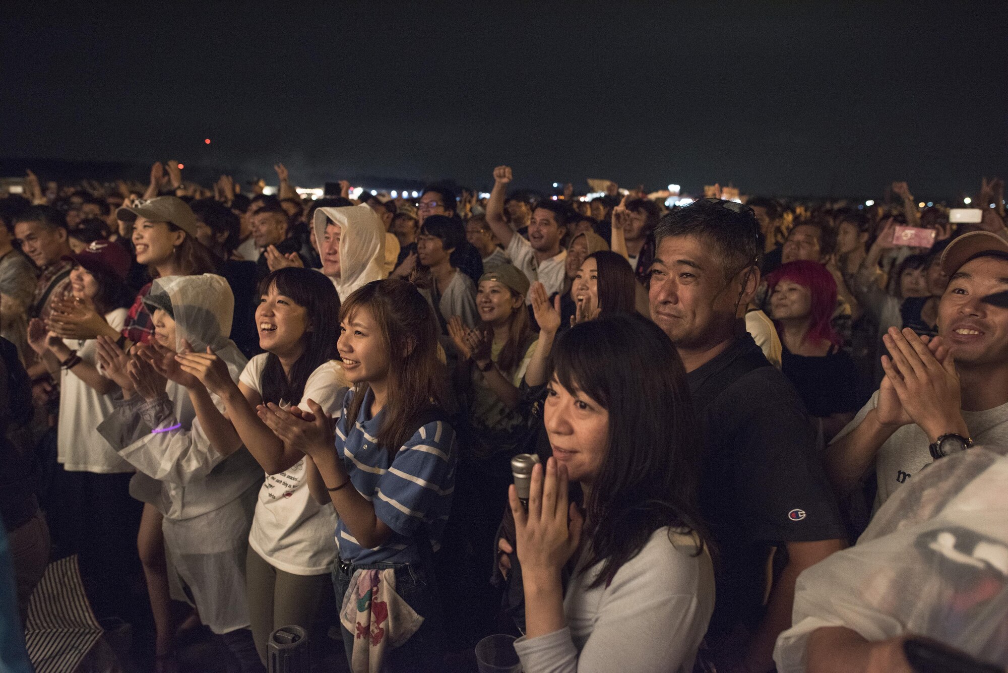The audience claps and dances to a performance by the Band of the Pacific-Asia during the 2016 Japanese-American Friendship Festival at Yokota Air Base, Japan, Sept. 17, 2016. Tens of thousands of people attend the festival every year to learn more about the US military and American culture and to enjoy performances and demonstrations. More than 185,000 people attended the festival in 2015. (U.S. Air Force photo by Staff Sgt. Cody H. Ramirez/Released)