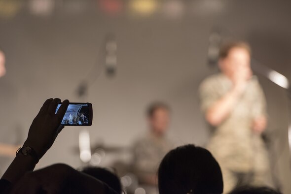 An audience member records a live performance by the Band of the Pacific-Asia during the 2016 Japanese-American Friendship Festival at Yokota Air Base, Japan, Sept. 17, 2016. The festival hosted food vendors, static aircraft displays, live entertainment and military and government demonstrations. (U.S. Air Force photo by Staff Sgt. Cody H. Ramirez/Released)