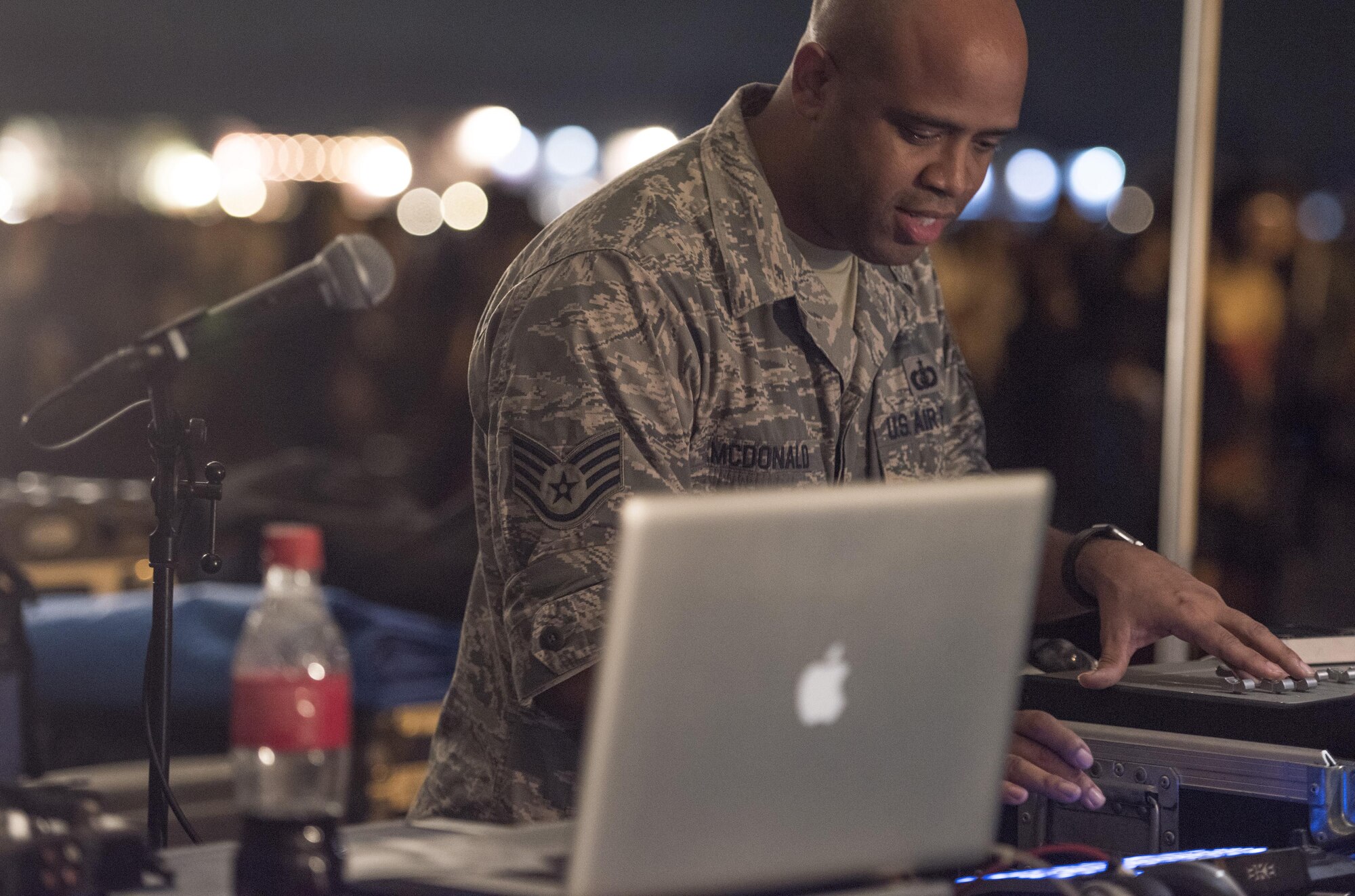 Staff Sgt. Kelcey McDonald, audio engineer with the Band of the Pacific-Asia, adjusts audio scales for a live performance during the 2016 Japanese-American Friendship Festival at Yokota Air Base, Japan, Sept. 17, 2016. Tens of thousands of people attend the festival every year to learn more about the US military and American culture and to enjoy performances and demonstrations. More than 185,000 people attended the festival in 2015. (U.S. Air Force photo by Staff Sgt. Cody H. Ramirez/Released)