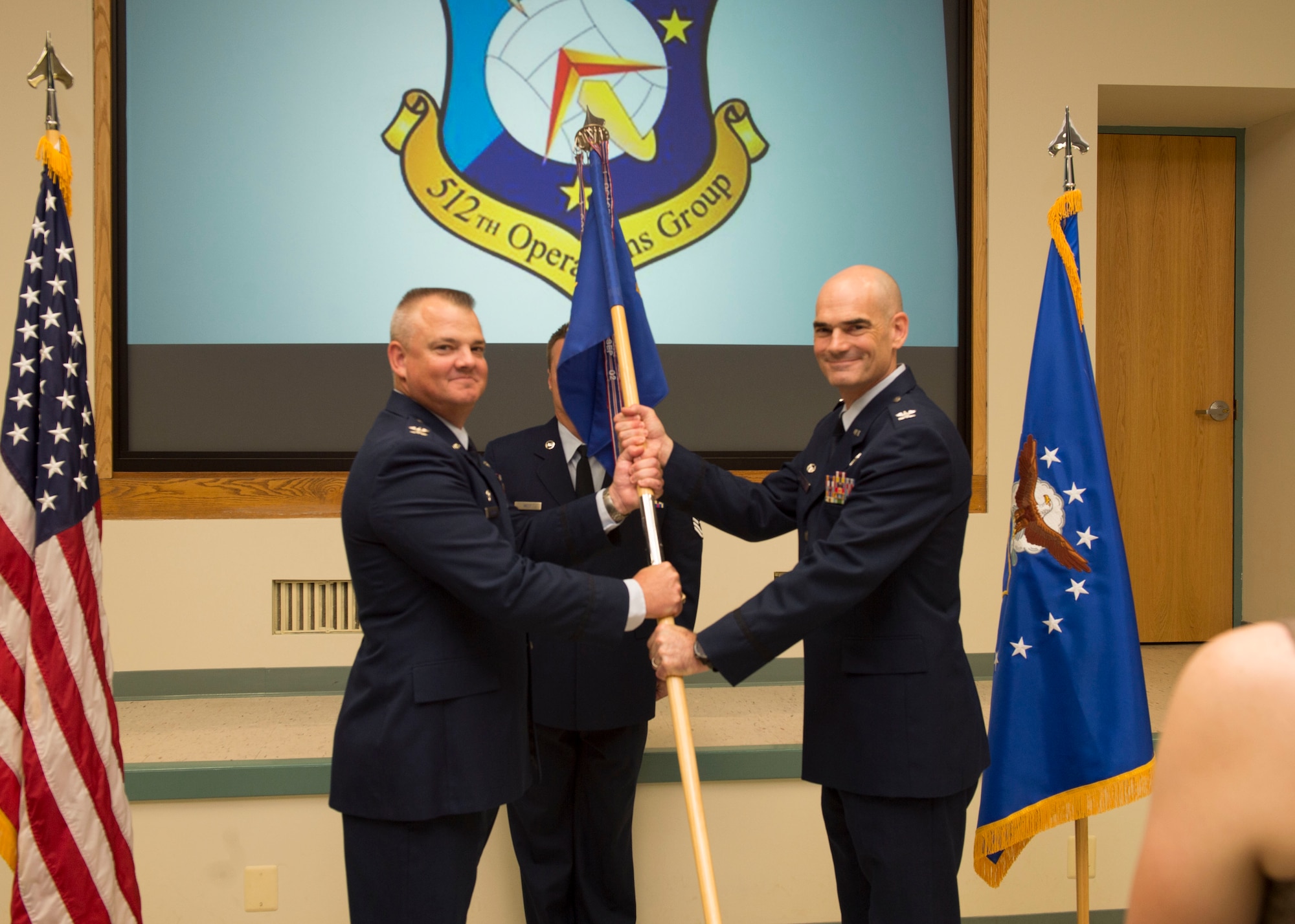 Col. Scott D. Durham, commander of the 512th Airlift Wing, and Col. William H. Gutermuth exchange the guidon at an assumption of command ceremony Sept. 17, 2016 at Dover Air Force Base, Del. Col. Guthermuth will be the new commander of the 512th Operations Group. (U.S. Air Force photo by Staff Sgt. Renee M. Jackson)