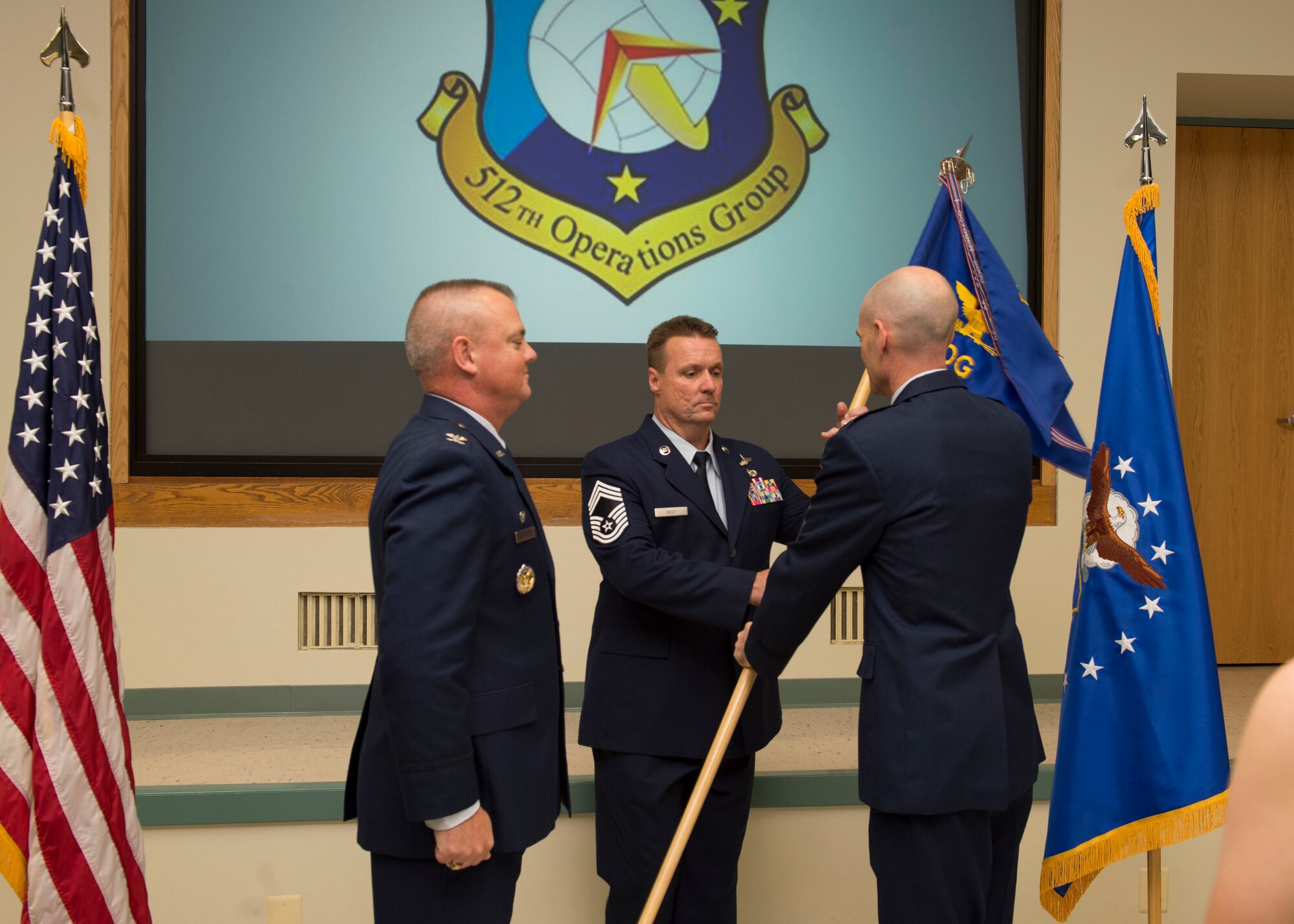 Col. Scott D. Durham, commander of the 512th Airlift Wing, and Col. William H. Gutermuth exchange the guidon at an assumption of command ceremony Sept. 17, 2016 at Dover Air Force Base, Del. Col. Guthermuth will be the new commander of the 512th Operations Group. (U.S. Air Force photo by Staff Sgt. Renee M. Jackson)