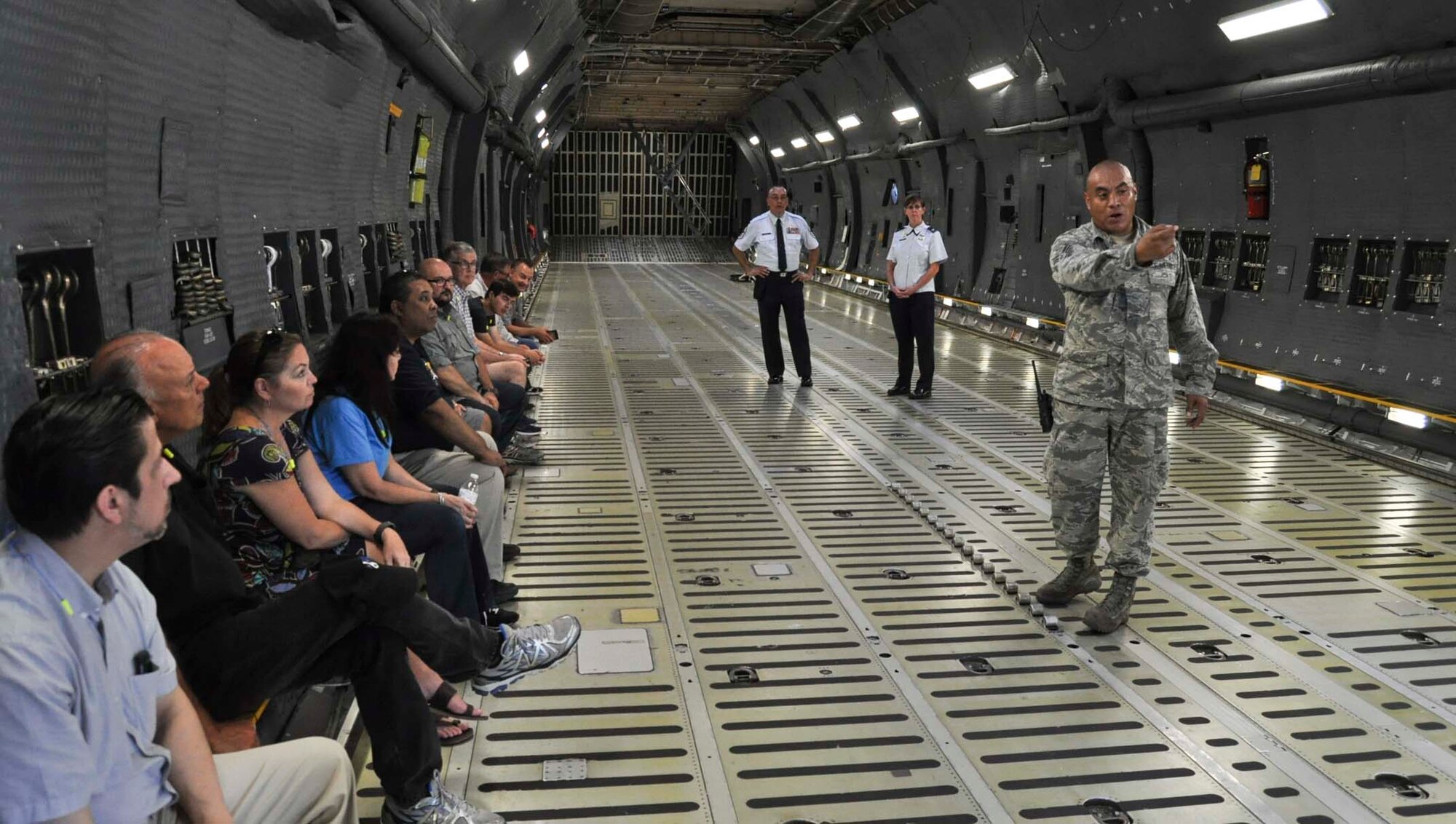 Tech. Sgt. David Ponce, 433rd Aircraft Maintenance Squadron dedicated crew chief, explains some of the features and upgrades of the new C-5M Super Galaxy aircraft to 433rd Airlift Wing honorary commanders Sept. 17, 2016 at Joint Base San Antonio-Lackland, Texas. This was the first honorary commander’s tour of the 433rd Maintenance Group since the Alamo Wing received the new C-5M models. (U.S. Air Force photo/Senior Airman Bryan Swink)