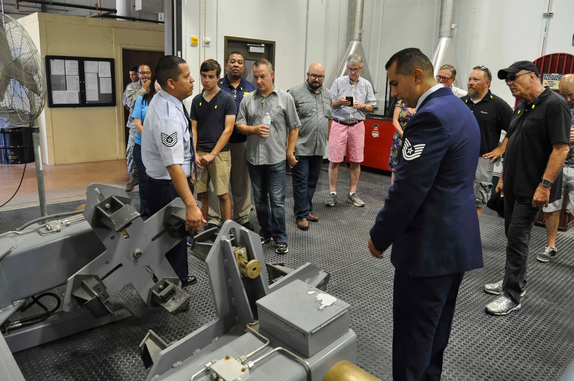 Tech Sgts. Victor Fernandez, left, and Charlie Morales, 433rd Maintenance Squadron aerospace wheel and tire technicians, demonstrate equipment used by the wheel and tire shop to 433rd Airlift Wing honorary commanders Sept. 17, 2016 during a tour of the 433rd Maintenance Group at Joint Base San Antonio-Lackland, Texas. The Airmen use the equipment to maintain and perform safety checks of the tires of the C-5M Super Galaxy. (U.S. Air Force photo/Senior Airman Bryan Swink)