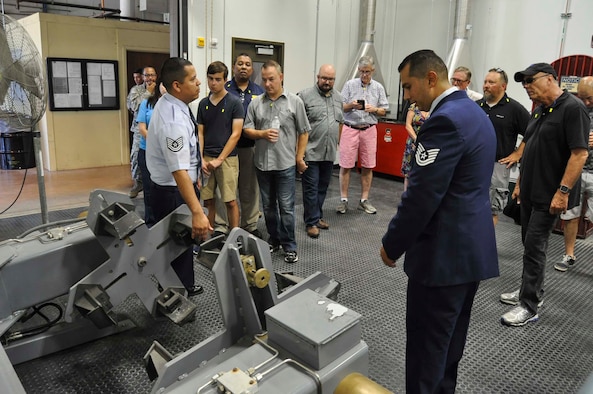 Tech Sgts. Victor Fernandez, left, and Charlie Morales, 433rd Maintenance Squadron aerospace wheel and tire technicians, demonstrate equipment used by the wheel and tire shop to 433rd Airlift Wing honorary commanders Sept. 17, 2016 during a tour of the 433rd Maintenance Group at Joint Base San Antonio-Lackland, Texas. The Airmen use the equipment to maintain and perform safety checks of the tires of the C-5M Super Galaxy. (U.S. Air Force photo/Senior Airman Bryan Swink)