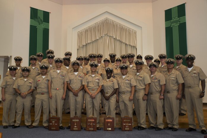U.S. Navy Sailors pose for a group photo during a promotion ceremony in the Marine Memorial Chapel at Marine Corps Air Station Iwakuni, Japan, Sept. 16, 2016. The newly promoted chief petty officers were joined by their peers as a sign of becoming something bigger than themselves. (U.S. Marine Corps photo by Lance Cpl. Joseph Abrego)