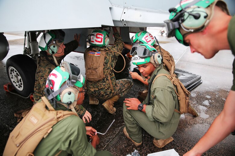 Powerliners assigned to Marine All Weather Fighter Attack Squadron (VMFA(AW)) 242 perform maintenance on an F/A-18D Hornet after a flight mission during Exercise Valiant Shield 16 at Andersen Air Force Base, Guam, Sept. 18, 2016. Powerliners, airframes mechanics, communication navigation and ordnance technicians, work around the clock to ensure flight schedules are met for aviation operations during the exercise. During this U.S.-only, biennial field training exercise, F/A-18D Hornets flew in a plethora of missions that emphasize joint integration, interoperability and expeditionary readiness. (U.S. Marine Corps photo by Sgt. Jessica Quezada) 