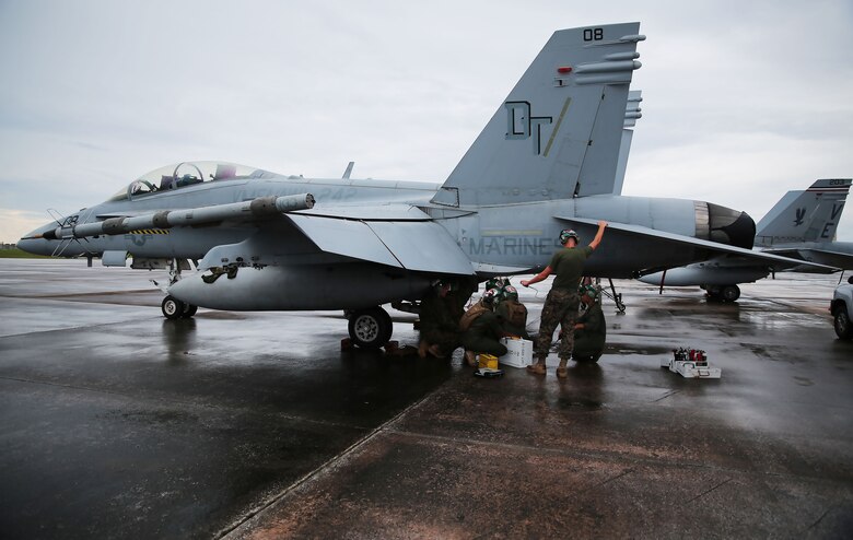 Powerliners assigned to Marine All Weather Fighter Attack Squadron (VMFA(AW)) 242 perform maintenance on an F/A-18D Hornet after a flight mission during Exercise Valiant Shield 16 at Andersen Air Force Base, Guam, Sept. 18, 2016. Powerliners, airframes mechanics, communication navigation and ordnance technicians, work around the clock to ensure flight schedules are met for aviation operations during the exercise. During this U.S.-only, biennial field training exercise, F/A-18D Hornets flew in a plethora of missions that emphasize joint integration, interoperability and expeditionary readiness. (U.S. Marine Corps photo by Sgt. Jessica Quezada) 