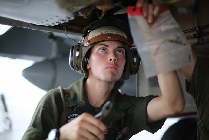 Lance Cpl. Nick Cox, a powerliner assigned to Marine All Weather Fighter Attack Squadron (VMFA(AW)) 242 performs maintenance on an F/A-18D Hornet after a flight mission during Exercise Valiant Shield 16 at Andersen Air Force Base, Guam, Sept. 18, 2016. Powerliners, airframes mechanics, communication navigation and ordnance technicians, work around the clock to ensure flight schedules are met for aviation operations during the exercise. During this U.S.-only, biennial field training exercise, F/A-18D Hornets flew in a plethora of missions that emphasize joint integration, interoperability and expeditionary readiness. (U.S. Marine Corps photo by Sgt. Jessica Quezada)