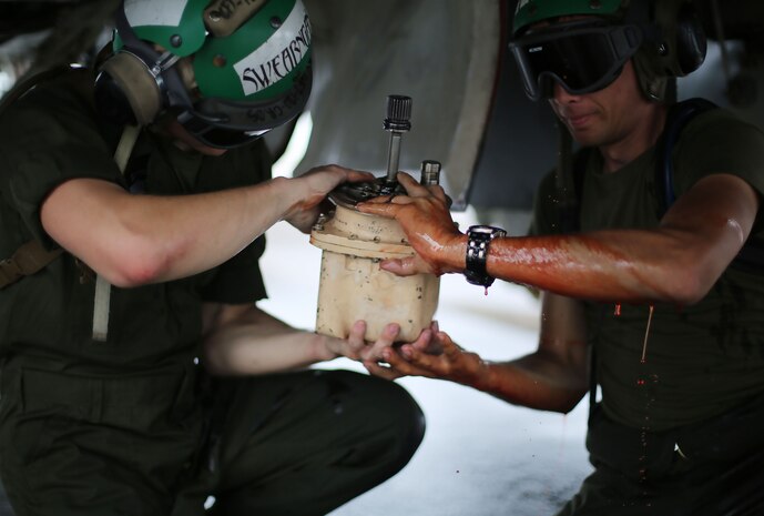 Airframes mechanics assigned to Marine All Weather Fighter Attack Squadron (VMFA(AW)) 242 remove a hydraulic pump from an F/A-18D Hornet after a flight mission during Exercise Valiant Shield 16 at Andersen Air Force Base, Guam, Sept. 18, 2016. Powerliners, airframes mechanics, communication navigation, and ordnance technicians, work around the clock to ensure flight schedules are met for aviation operations during the exercise. During this U.S.-only, biennial field training exercise, F/A-18D Hornets flew in a plethora of missions that emphasize joint integration, interoperability and expeditionary readiness. (U.S. Marine Corps photo by Sgt. Jessica Quezada) 