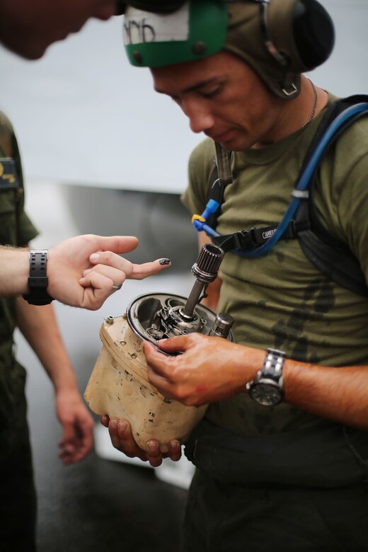 Lance Cpl. Cody Hanink, an airframes mechanic assigned to Marine All Weather Fighter Attack Squadron (VMFA(AW)) 242 removes a hydraulic pump from an F/A-18D Hornet after a flight mission during Exercise Valiant Shield 16 at Andersen Air Force Base, Guam, Sept. 18, 2016. Powerliners, airframes mechanics, communication navigation, and ordnance technicians, work around the clock to ensure flight schedules are met for aviation operations during the exercise. During this U.S.-only, biennial field training exercise, F/A-18D Hornets flew in a plethora of missions that emphasize joint integration, interoperability and expeditionary readiness. (U.S. Marine Corps photo by Sgt. Jessica Quezada) 