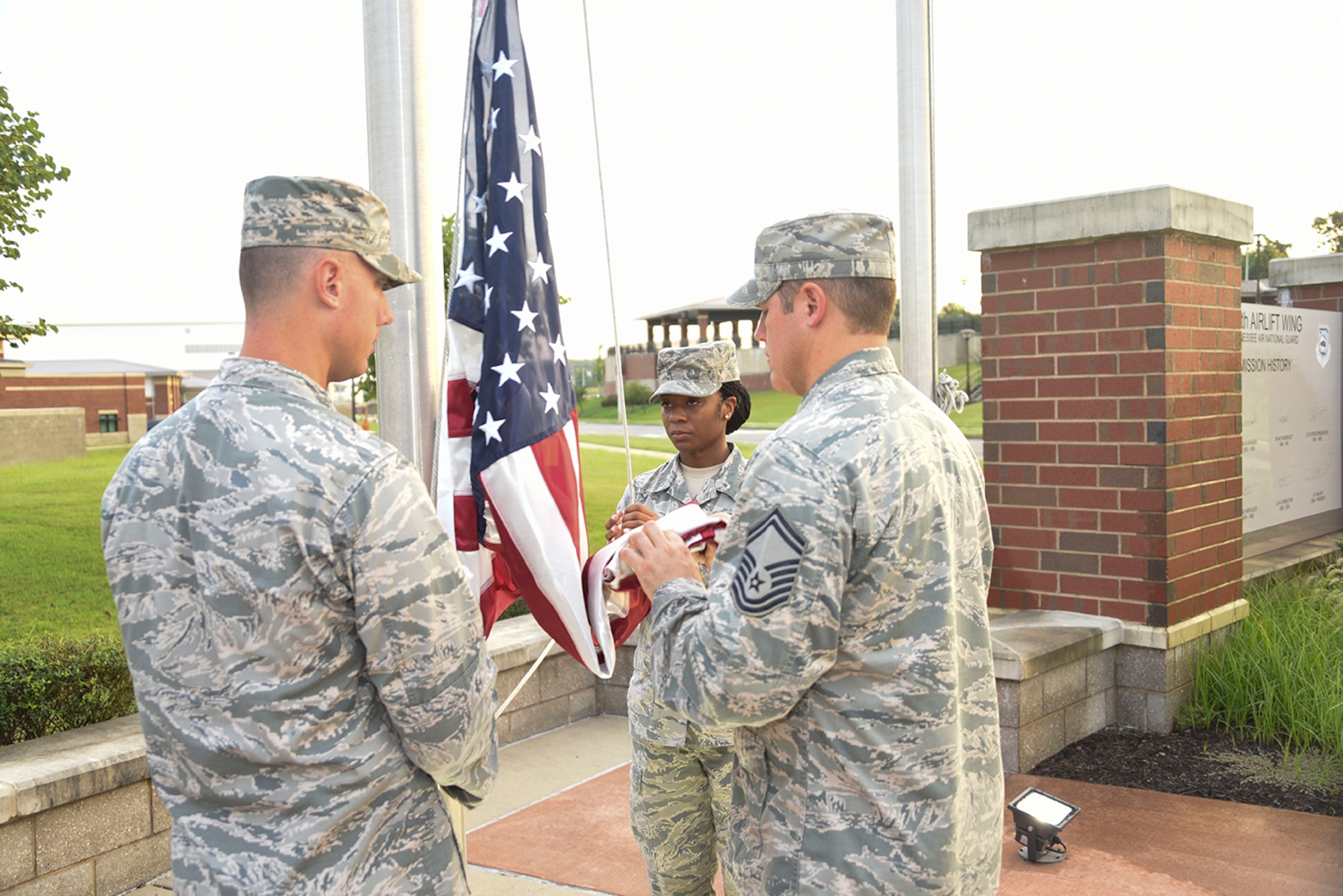 Senior Master Sergeant Matthew Smith begins to fold the American flag during the Retreat ceremony at the 164th Airlift Wing in Memphis, Tenn on August 7, 2016. (U.S. Air National Guard photo by Master Sergeant Danial Mosher/Released)