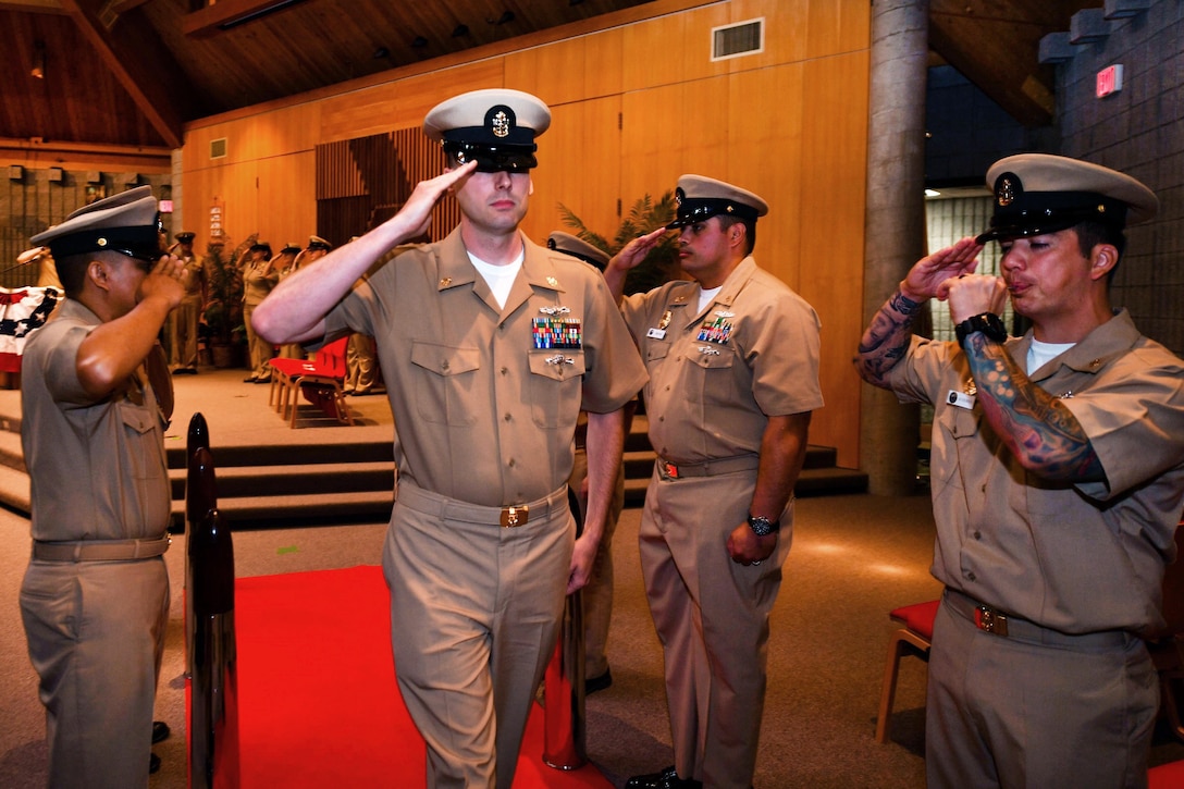 Newly promoted Navy Chief Petty Officer Bobby Anderson passes through the “sideboys” during a chief petty officer pinning ceremony in the Naval Base Kitsap Bangor Chapel at Silverdale, Wash., Sept. 16, 2016. Anderson is an Information systems technician. Navy photo by Petty Officer 3rd Class Charles D. Gaddis IV