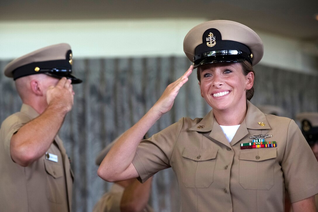 Newly promoted Navy Chief Petty Officer Chelsea Overman passes through the “sideboys” during a pinning ceremony at Hickam Officer's Club Lanai, Joint Base Pearl Harbor-Hickam, Pearl Harbor, Sept. 16, 2016. Overman is a cryptologic technician-networks. Navy photo by Petty Officer 2nd Class Laurie Dexter