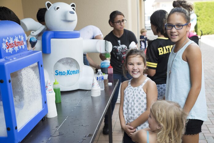 Children wait for shaved ice during the Boys and Girls Club Day for Kids Celebration 2016 at Marine Corps Air Station Iwakuni, Japan, Sept. 17, 2016. All kids, 17 years of age and younger, were invited out for entertainment, food and beverages with the local community. (U.S. Marine Corps photo by Lance Cpl. Joseph Abrego)