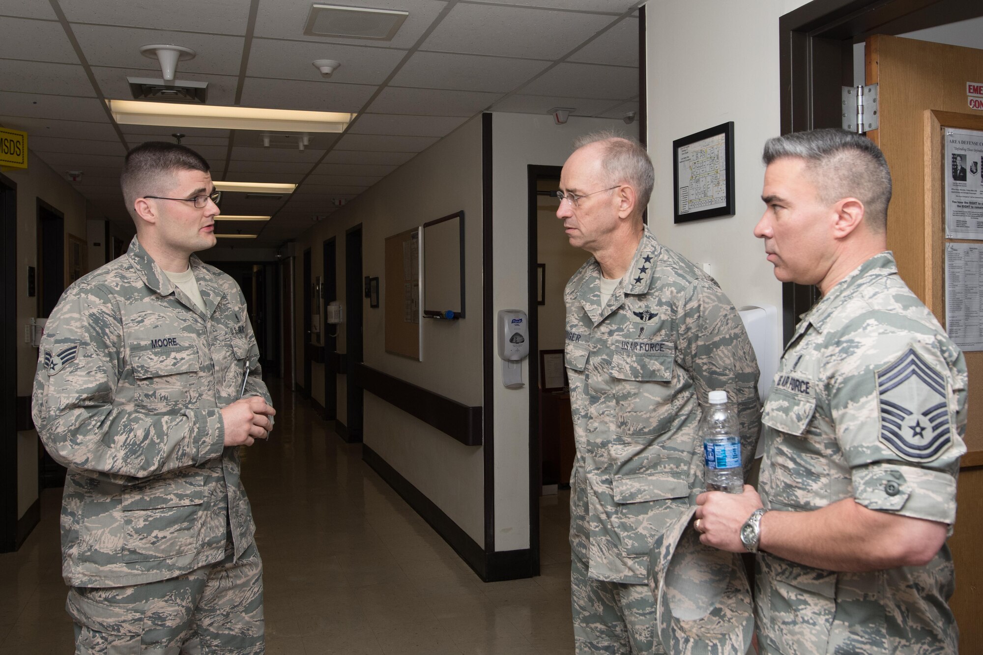 U.S. Air Force Senior Airman Patrick Moore, 51st Medical Operation Squadron emergency medical technician, speaks with Lt. Gen. (Dr.) Mark A. Ediger, Surgeon General of the Air Force, Headquarters U.S. Air Force, Washington, D.C., and Chief Master Sgt. Jason Pace, Office of the Surgeon General medical enlisted force chief, during a tour of the 51st Medical Group Sept. 14, 2016, at Osan Air Base, Republic of Korea. Ediger and Pace toured various medical facilities within the group to observe the progress and challenges of AF military treatment facilities. (U.S. Air Force photo by Senior Airman Dillian Bamman)