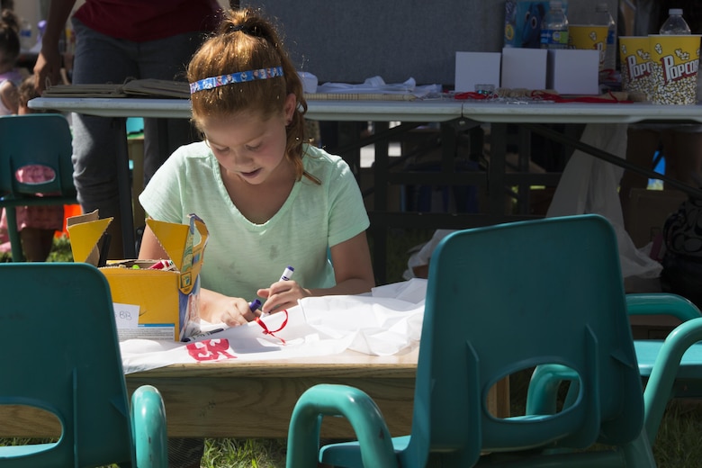 A child attending the Boys and Girls Club Day for Kids Celebration 2016 colors at Marine Corps Air Station Iwakuni, Japan, Sept. 17, 2016. Day for Kids gave children an opportunity to have fun and interact with other children in a safe environment. (U.S. Marine Corps photo by Lance Cpl. Joseph Abrego) 