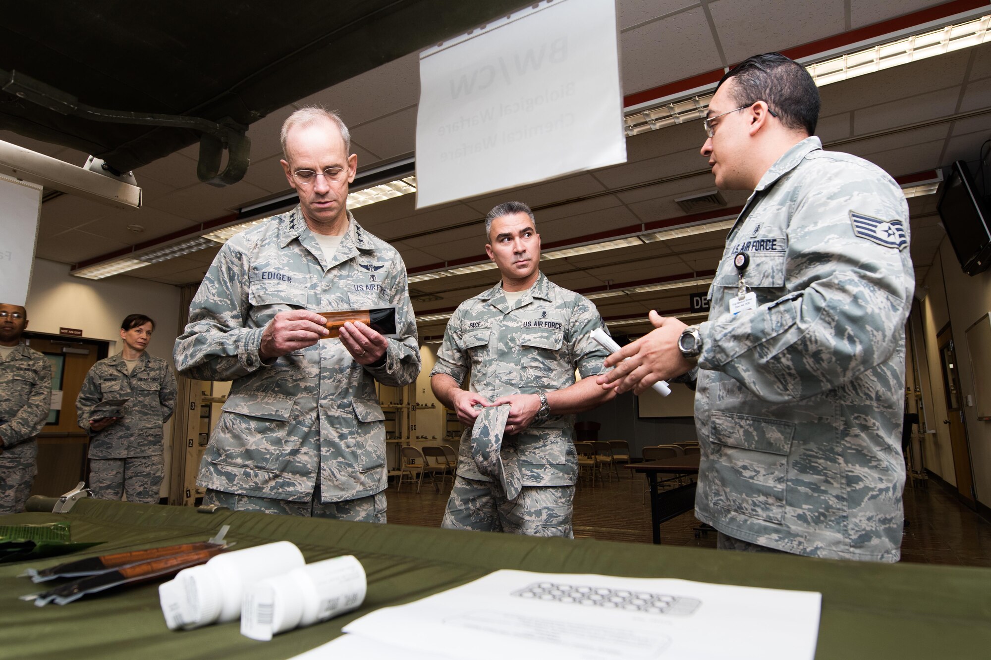 Lt. Gen. (Dr.) Mark A. Ediger, Surgeon General of the Air Force, Headquarters U.S. Air Force, Washington, D.C., and Chief Master Sgt. Jason Pace, Office of the Surgeon General medical enlisted force chief, receive a briefing by Staff Sgt. Johan Rodriguez, 51st Medical Support Squadron logistics technician, on the 51st Medical Group’s Biological Warfare/Chemical Warfare program Sept. 14, 2016, at Osan Air Base, Republic of Korea. The BW/CW program is designed to take contingency medical care and import it into squadrons across Osan to better prepare for contingency operations. (U.S. Air Force photo by Senior Airman Dillian Bamman)