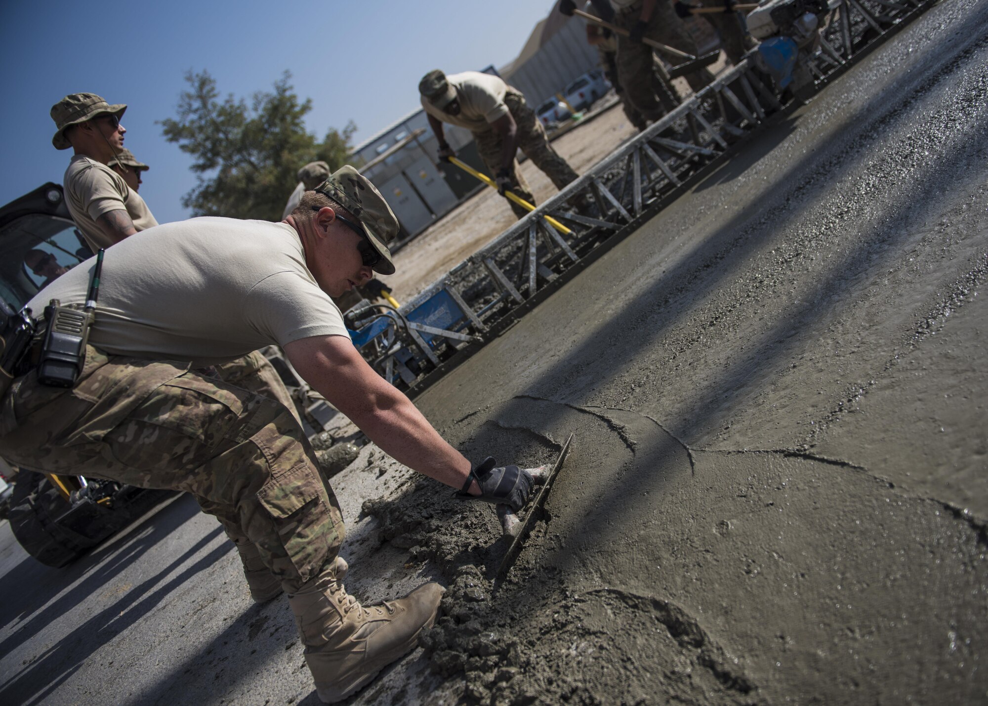 Staff Sgt. Casey Pentecost, 455th Expeditionary Civil Engineer Squadron pavements and equipment, smooths out concrete mixture, Bagram Airfield, Afghanistan, Sept. 19, 2016. The ECES “dirtboys” along with volunteers from various base units placed concrete down to extend a parking lot. (U.S. Air Force photo by Senior Airman Justyn M. Freeman)