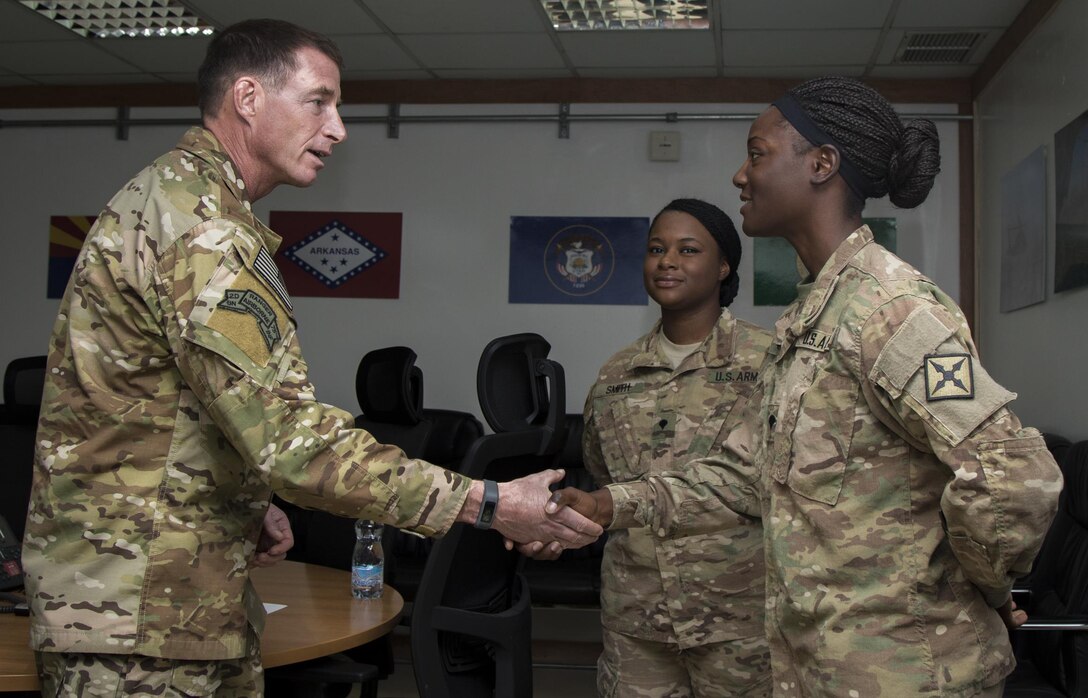 Command Sgt. Maj. William Thetford, left, the senior enlisted leader of U.S. Central Command, presents a coin to Spc. Rena Hildreth, right, a unit supply specialist with the 77th Combat Aviation Brigade on Sep. 15, 2016 at Camp Buehring, Kuwait. Thetford recognized several Soldiers with coins for their military excellence during his two-day visit to Kuwait. (U.S. Army photo by Sgt. Angela Lorden)