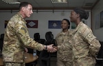 Command Sgt. Maj. William Thetford, left, the senior enlisted leader of U.S. Central Command, presents a coin to Spc. Rena Hildreth, right, a unit supply specialist with the 77th Combat Aviation Brigade on Sep. 15, 2016 at Camp Buehring, Kuwait. Thetford recognized several Soldiers with coins for their military excellence during his two-day visit to Kuwait. (U.S. Army photo by Sgt. Angela Lorden)