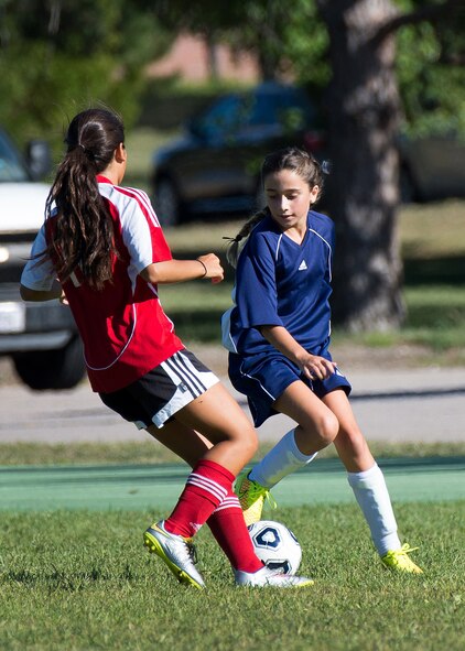 Lucia Martinkus, right, a member of the Hanscom Middle School Falcons girls' soccer team, competes for the ball during a home match against Lincoln Middle School at Hanscom Air Force Base, Mass., Sept 15. Hanscom Middle School lost the match 4-0. (U.S. Air Force photo by Mark Herlihy)