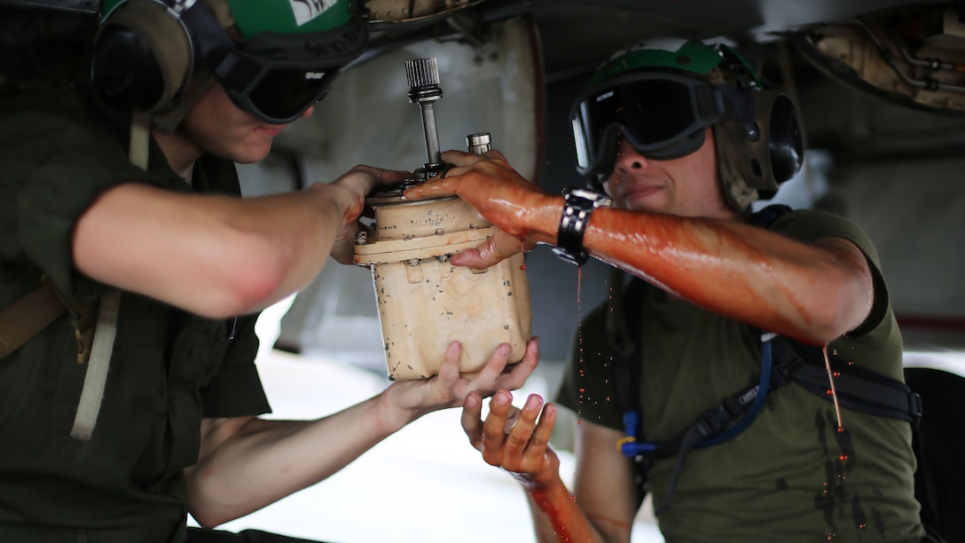 Airframes mechanics assigned to Marine All Weather Fighter Attack Squadron 242 remove a hydraulic pump from an F/A-18D Hornet after a flight mission during Exercise Valiant Shield 16 at Andersen Air Force Base, Guam, Sept. 18, 2016. Powerliners, airframes mechanics, communication navigation, and ordnance technicians, work around the clock to ensure flight schedules are met for aviation operations during the exercise. During this U.S.-only, biennial field training exercise, F/A-18D Hornets flew in a plethora of missions that emphasize joint integration, interoperability and expeditionary readiness.