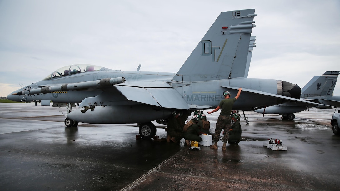 Powerliners assigned to Marine All Weather Fighter Attack Squadron 242 perform maintenance on an F/A-18D Hornet after a flight mission during Exercise Valiant Shield 16 at Andersen Air Force Base, Guam, Sept. 18, 2016. Powerliners, airframes mechanics, communication navigation, and ordnance technicians, work around the clock to ensure flight schedules are met for aviation operations during the exercise. During this U.S.-only, biennial field training exercise, F/A-18D Hornets flew in a plethora of missions that emphasize joint integration, interoperability and expeditionary readiness.