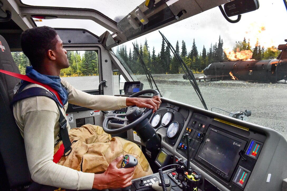 Air Force Senior Airman Larry Kyles drives a striker vehicle -- a specialized aircraft rescue and firefighting vehicle -- during firefighter training at Joint Base Elmendorf-Richardson, Alaska, Sept. 14, 2016. Kyles is a firefighter assigned to the 673rd Civil Engineer Squadron. Air Force photo by Justin Connaher