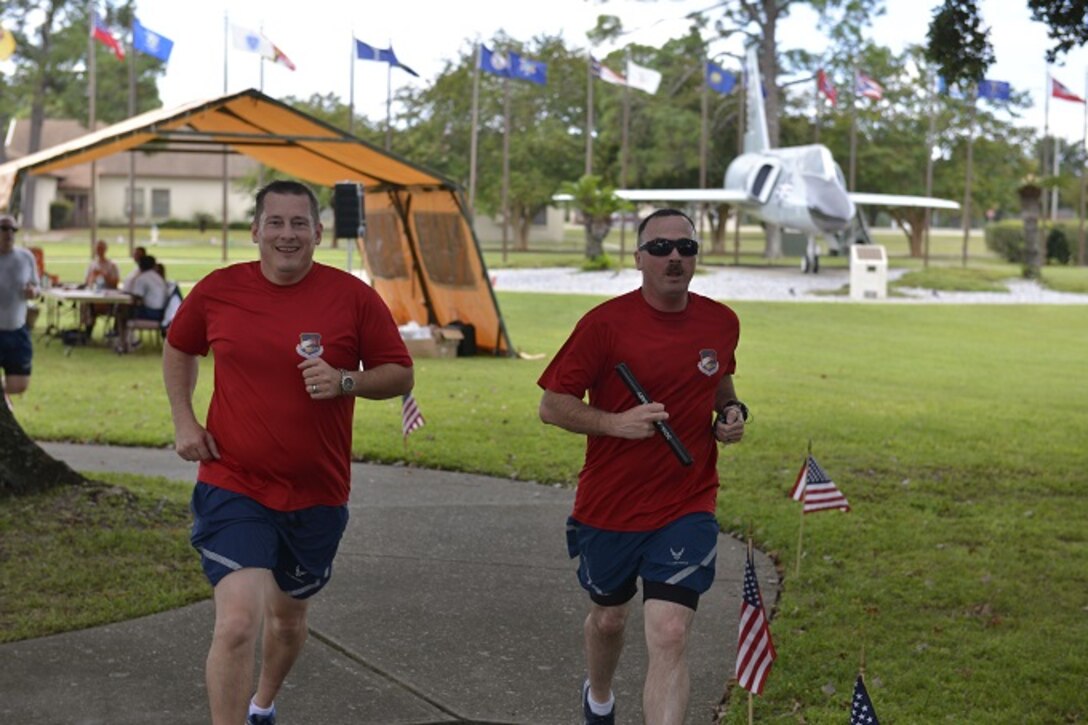 Major William Glen (left) and Master Sgt. Michael White Continental U.S. North American Aerospace Defense Command Region and 1st Air Force (Air Forces Northern) participate in the POW/MIA Vigil Run at Tyndall AFB. The 24-hour event was hosted by the 81st Range Control Squadron and included participants from many Tyndall AFB units. (U.S. Air Force photo by TSgt. Ed Staton)