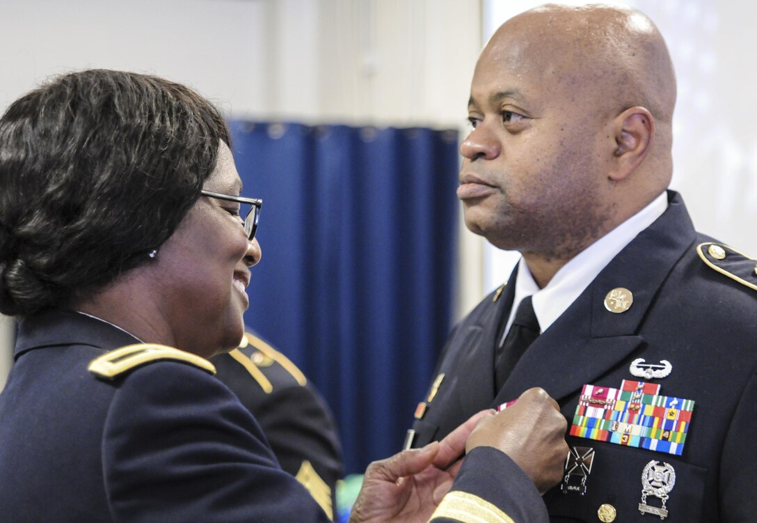 Army Brig. Gen. (Retired) Kaffia Jones pins the Meritorious Service Medal on Master Sgt. Eric Cuffee, recent G3 operations noncommissioned officer in charge, 335th Signal Command (Theater), during his retirement ceremony in East Point, Georgia, Sept. 17, 2016. Cuffee served more than 30-years of honorable and faithful service in the U.S. Army and U.S. Army Reserve.