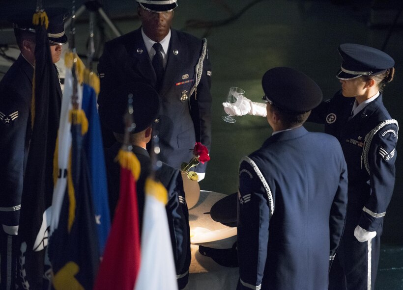Members of the Eglin Air Force Base honor guard perform a POW/MIA table setting at the Recognition Day event Sept. 16 at the Air Force Armament Museum. The ceremony paid tribute to those military members who have yet to return home from defending America. The event featured tributes, guest speakers and honor guard procedures. (U.S. Air Force photo/Samuel King Jr.)